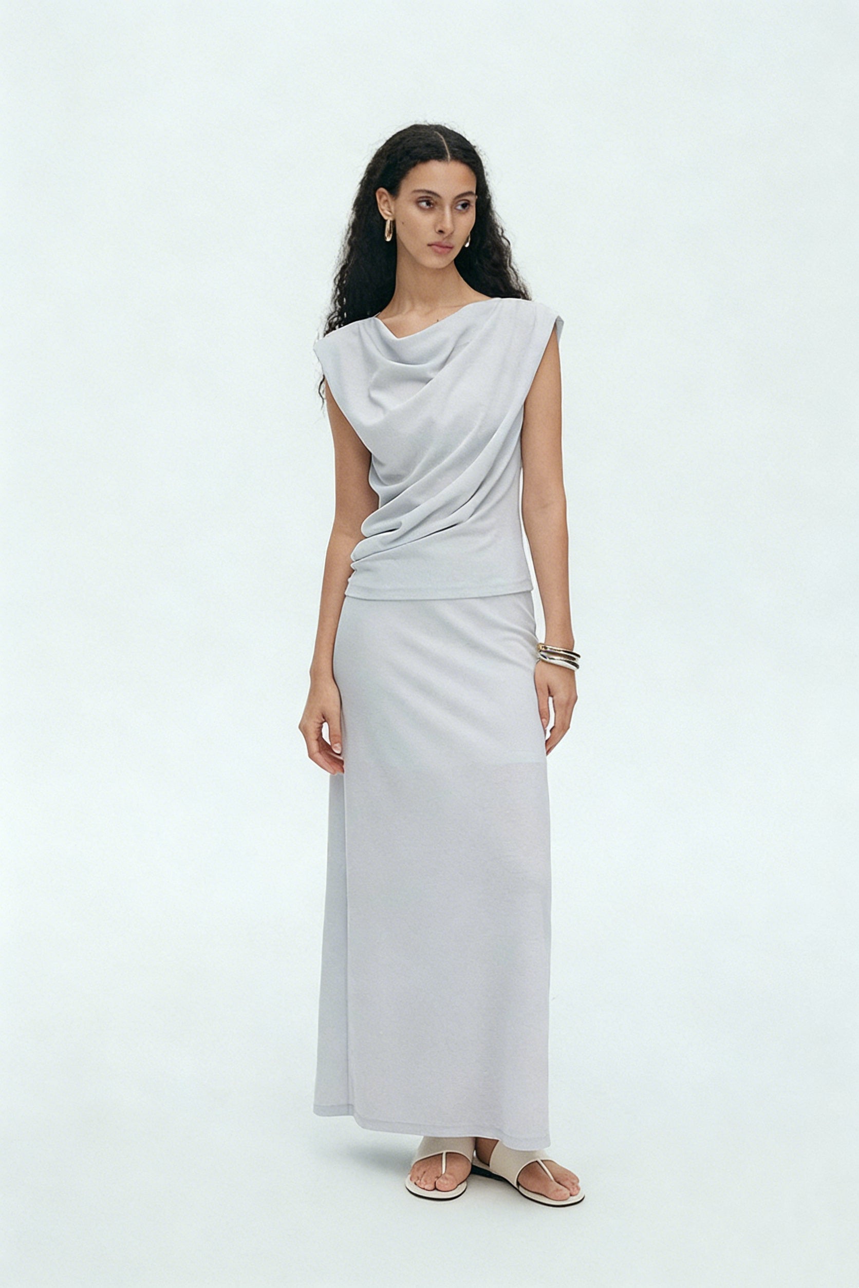 BapHood light gray draped sleeveless top with long maxi skirt creating elegant minimalist silhouette