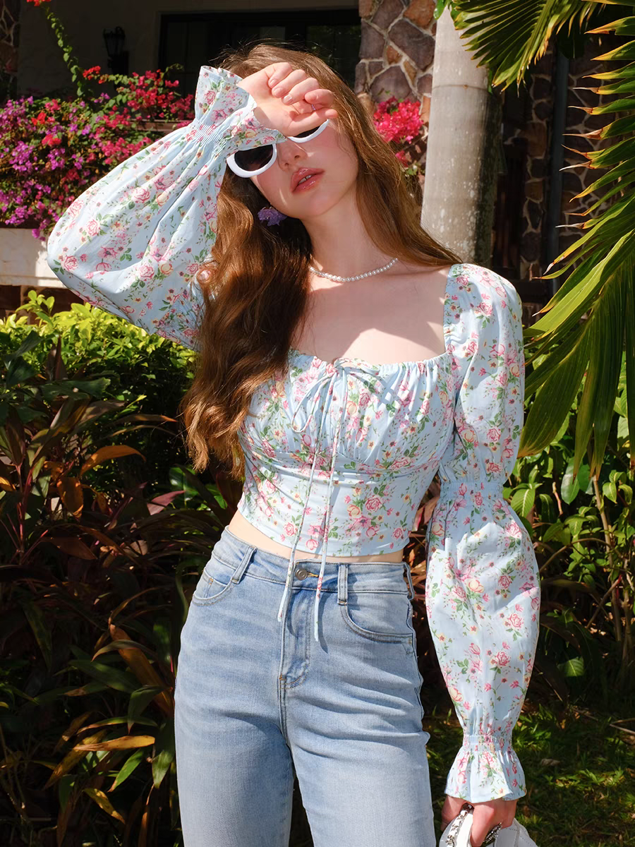 Close-up of vintage floral corset puff-sleeve blouse in sunlight