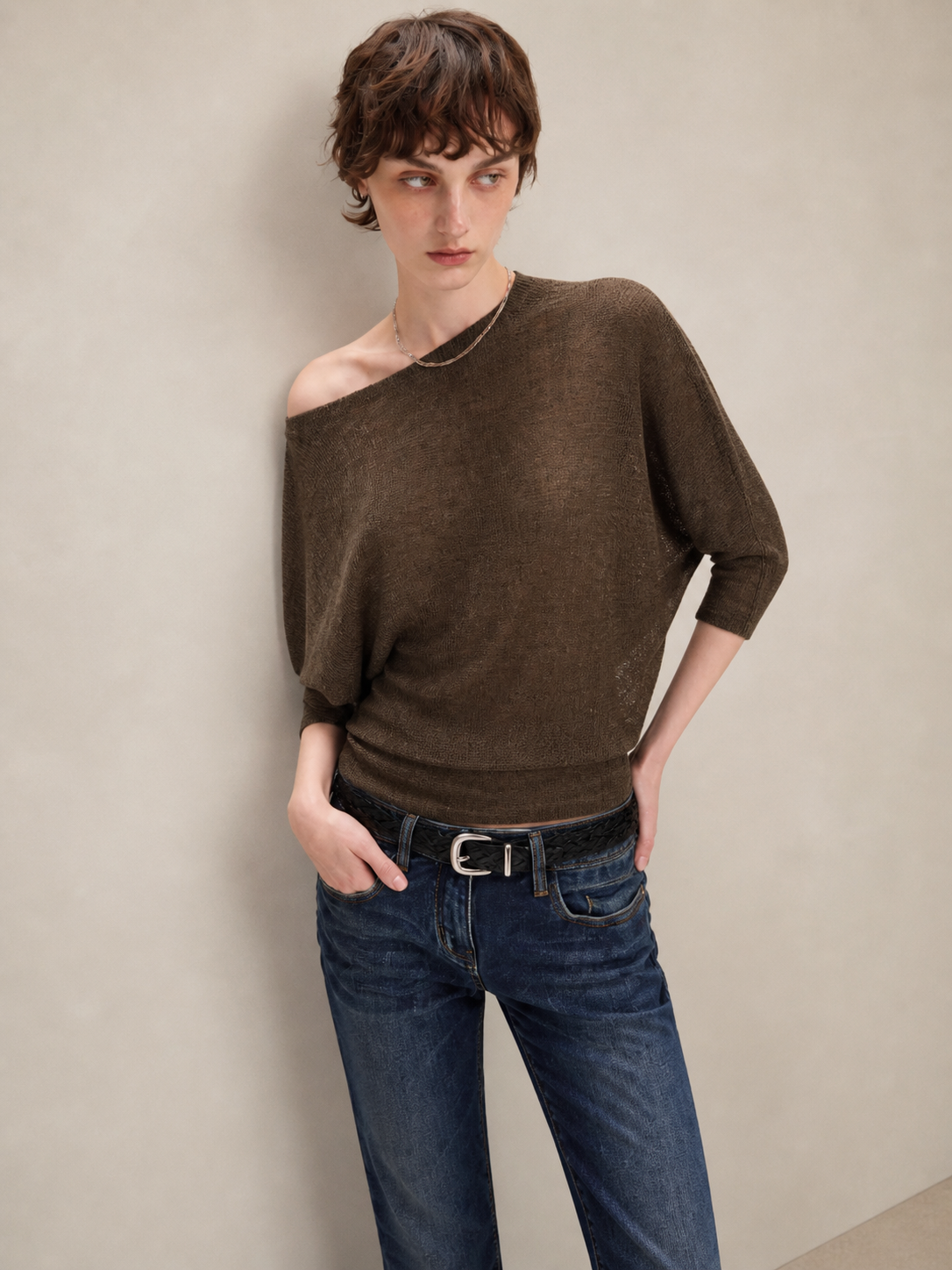 Brown asymmetric off shoulder batwing knit top, close-up view