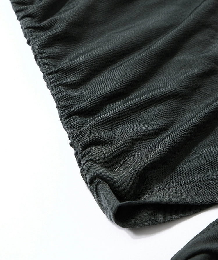 Close-up of ruched fabric on black maxi dress