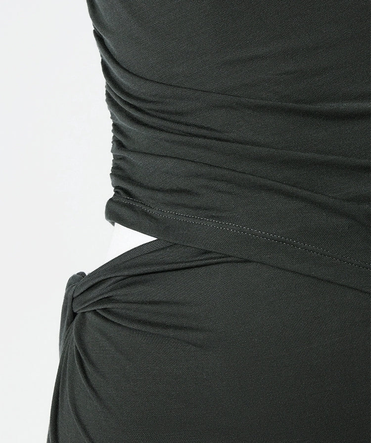 Close-up of ruched waist detail on black maxi dress