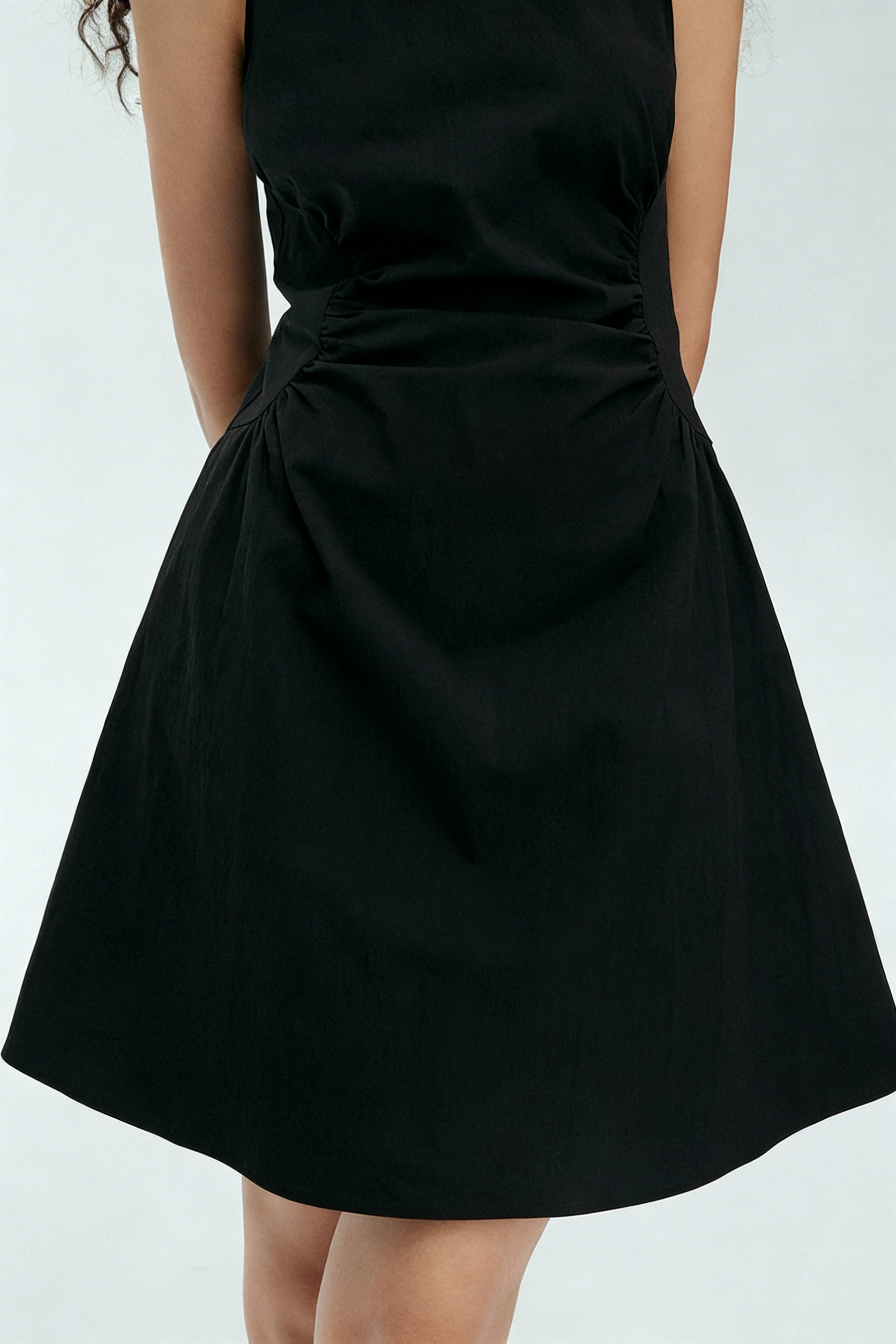 BapHood black sleeveless mini dress featuring gathered waist detail and clean high neckline