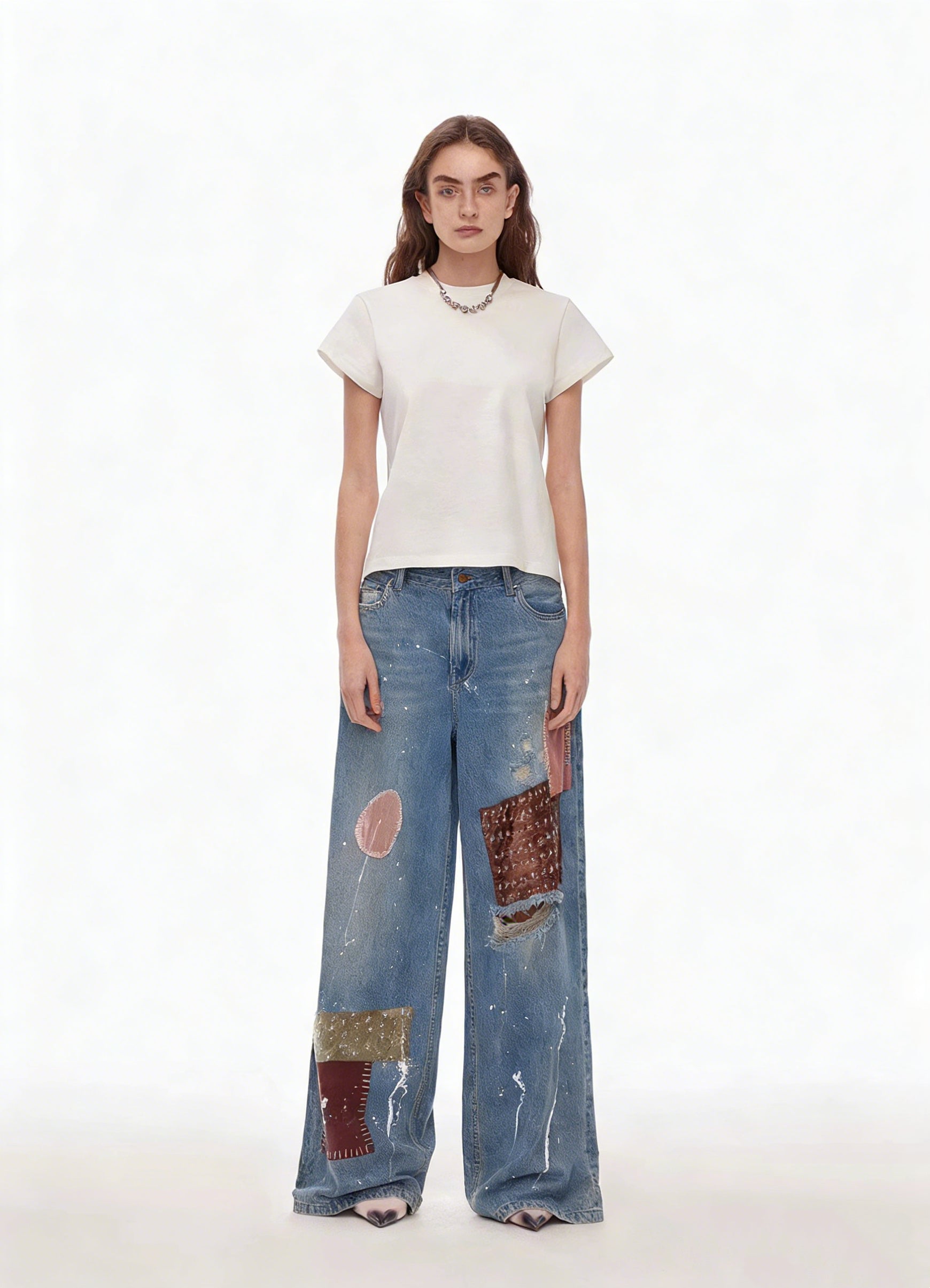 Blue patchwork distressed wide-leg jeans on model