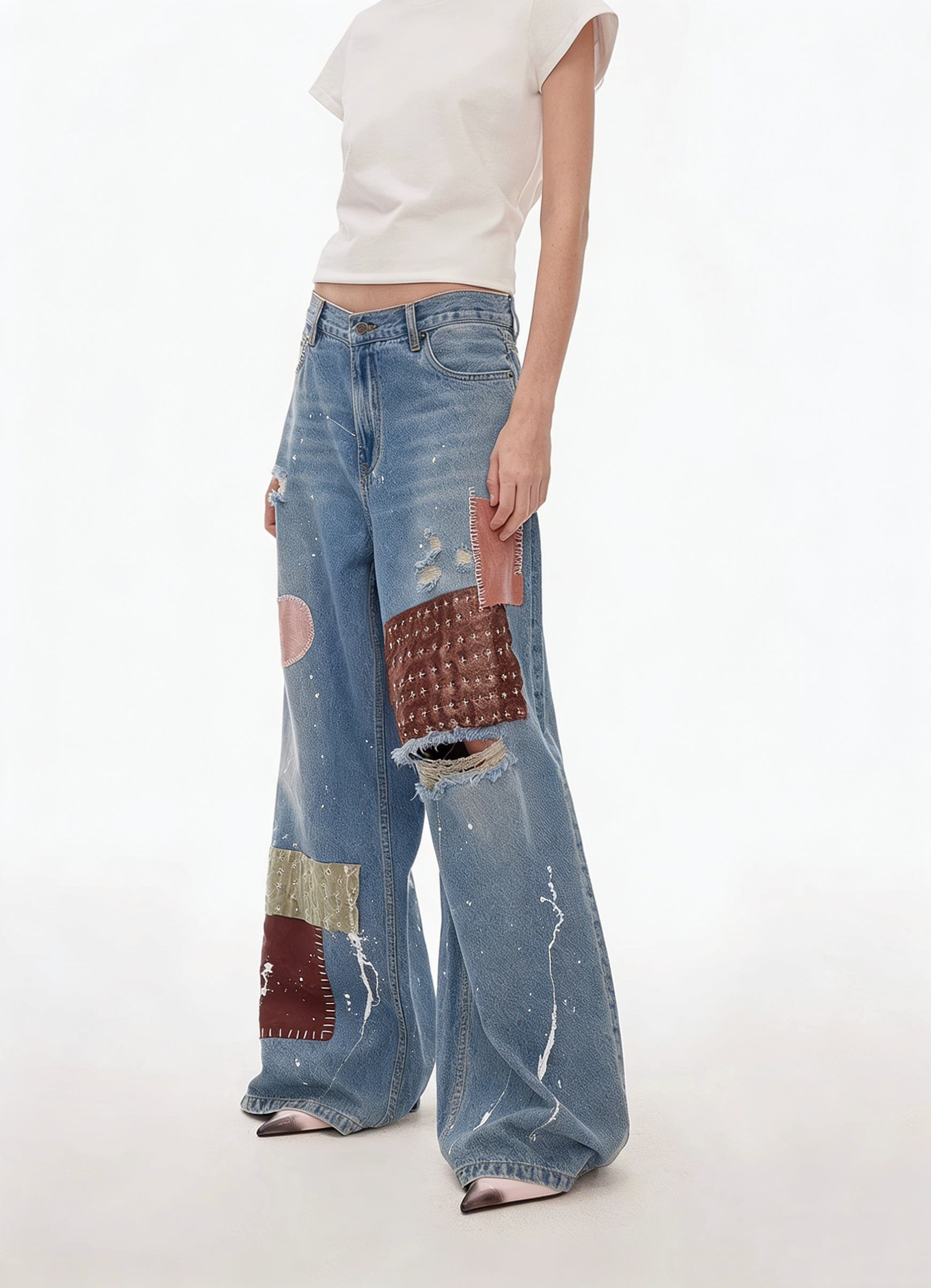 Side back view of blue patchwork distressed wide-leg jeans
