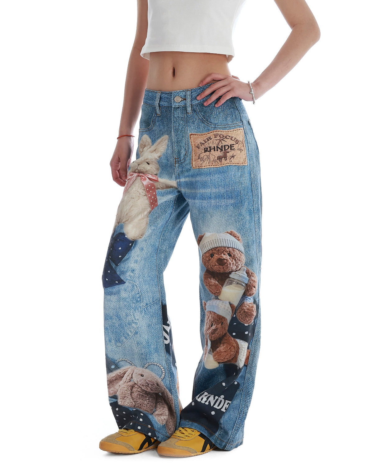 BapHood blue printed denim jeans with close detail views of teddy graphics and patchwork panels.