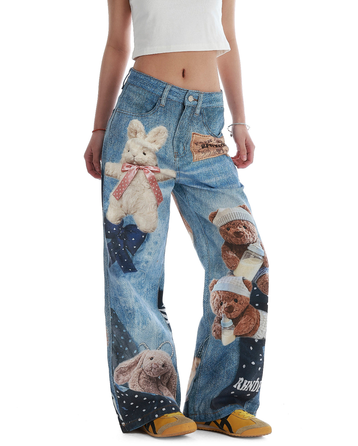 BapHood blue teddy print wide-leg jeans shown from an angle with patchwork-style graphic placement.