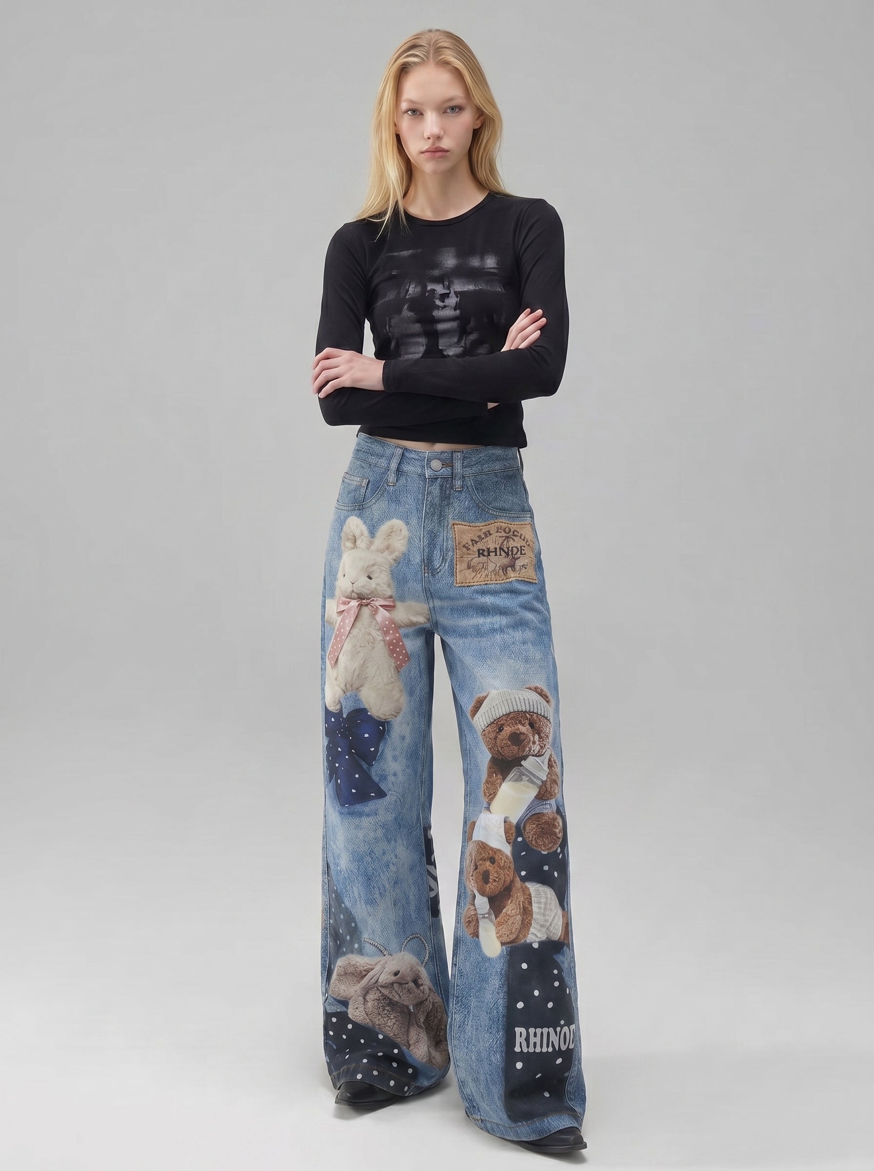 BapHood blue teddy print wide-leg jeans with patchwork graphics and a relaxed floor-length fit.