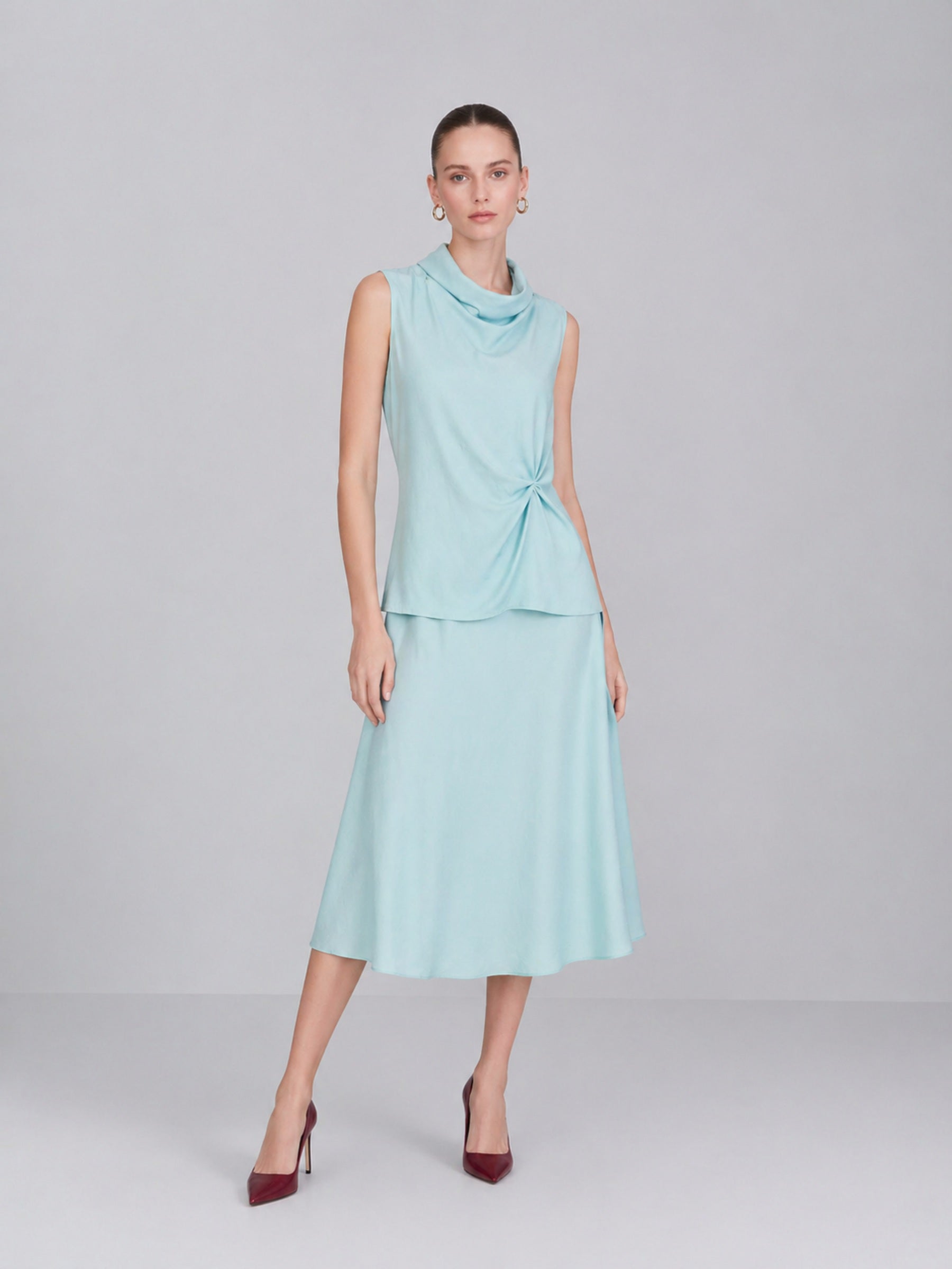 BapHood blue minimalist skirt set on model with draped sleeveless top and soft A-line skirt