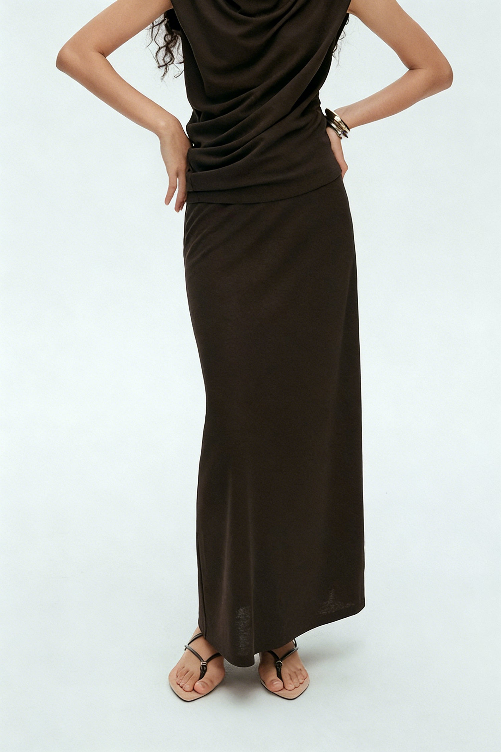 BapHood brown draped sleeveless top detail paired with fluid maxi skirt in minimalist two-piece outfit