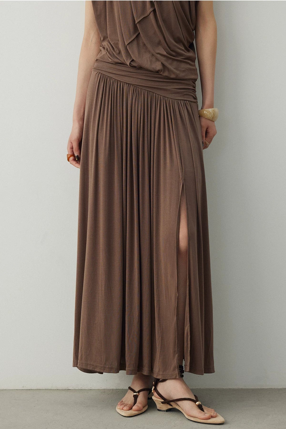 BapHood brown maxi skirt set showing the high-waist fit, ruched texture, and subtle side slit detail.