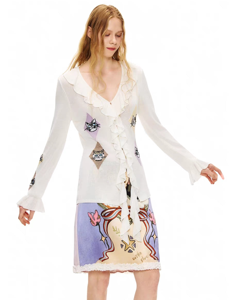 Angled front view of ruffle V-neck tie-front kitty argyle cardigan top