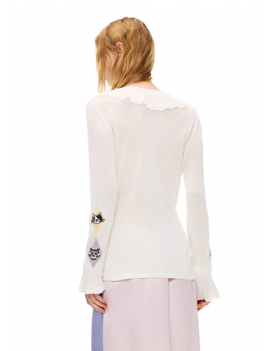 Back view of ivory long sleeve cardigan top with ruffle trim at neckline