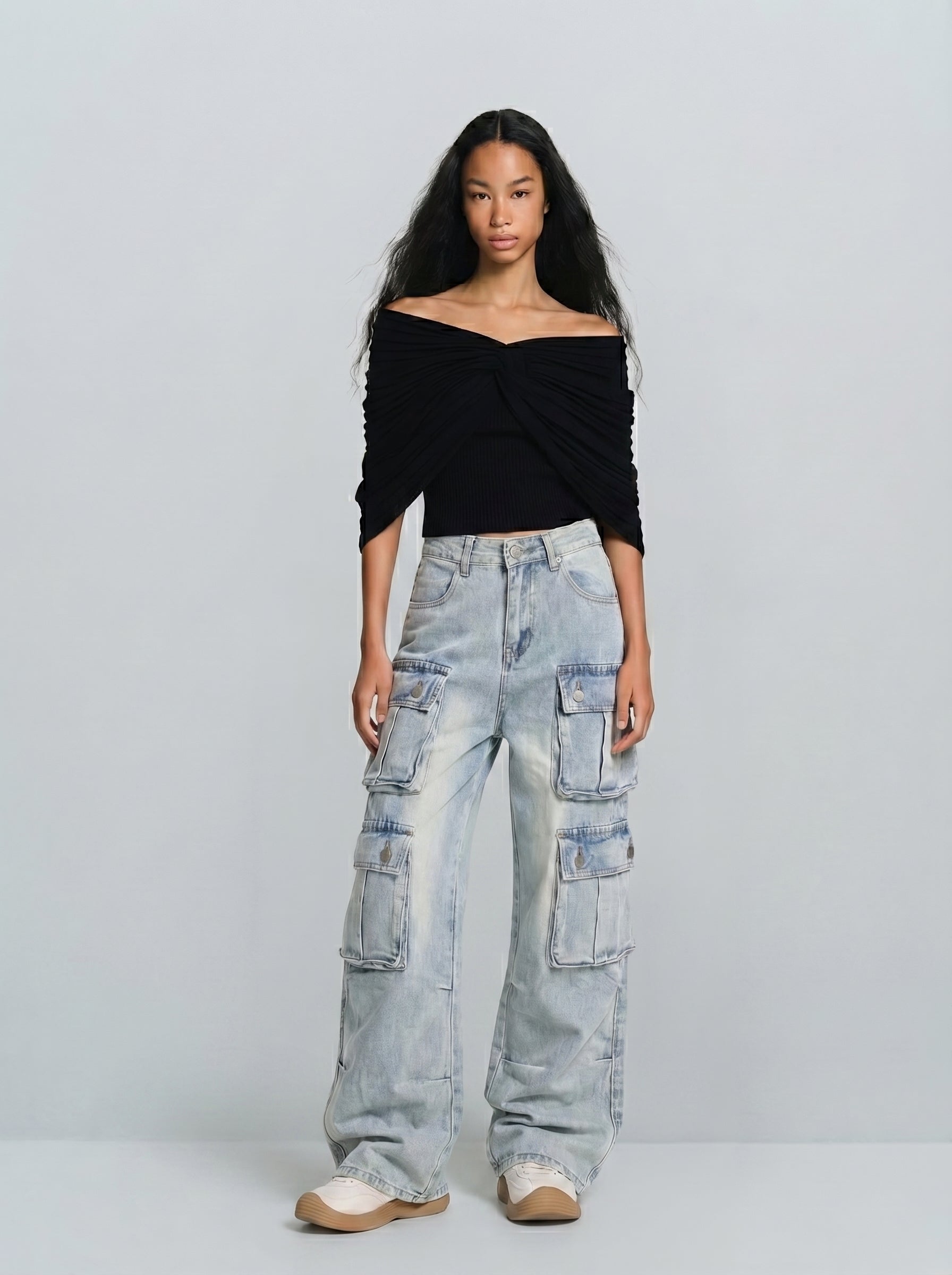 Full-body view of 6-pocket utility cargo jeans in light wash