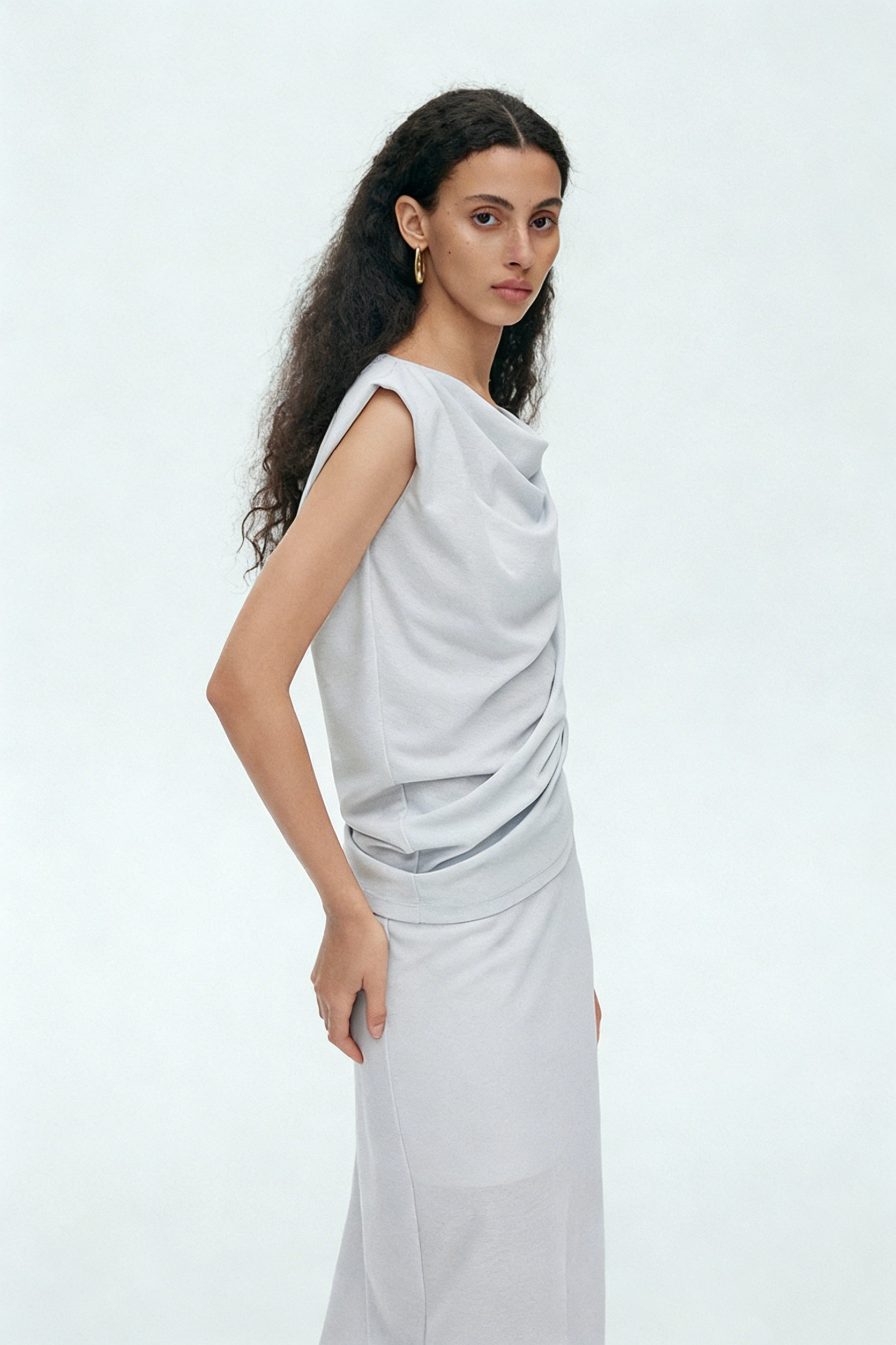 BapHood light gray draped sleeveless top with elegant cowl neckline paired with matching maxi skirt