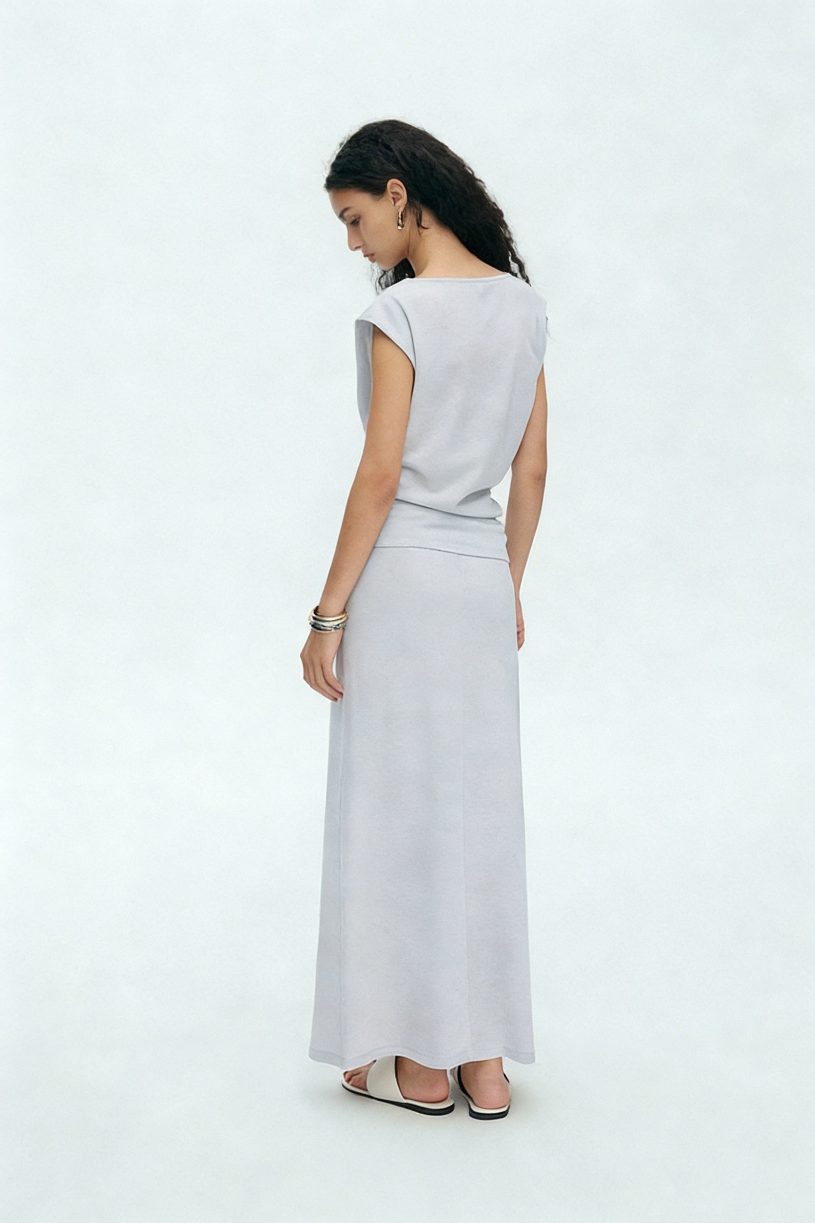 BapHood light gray sleeveless draped top and matching maxi skirt two-piece set shown from back