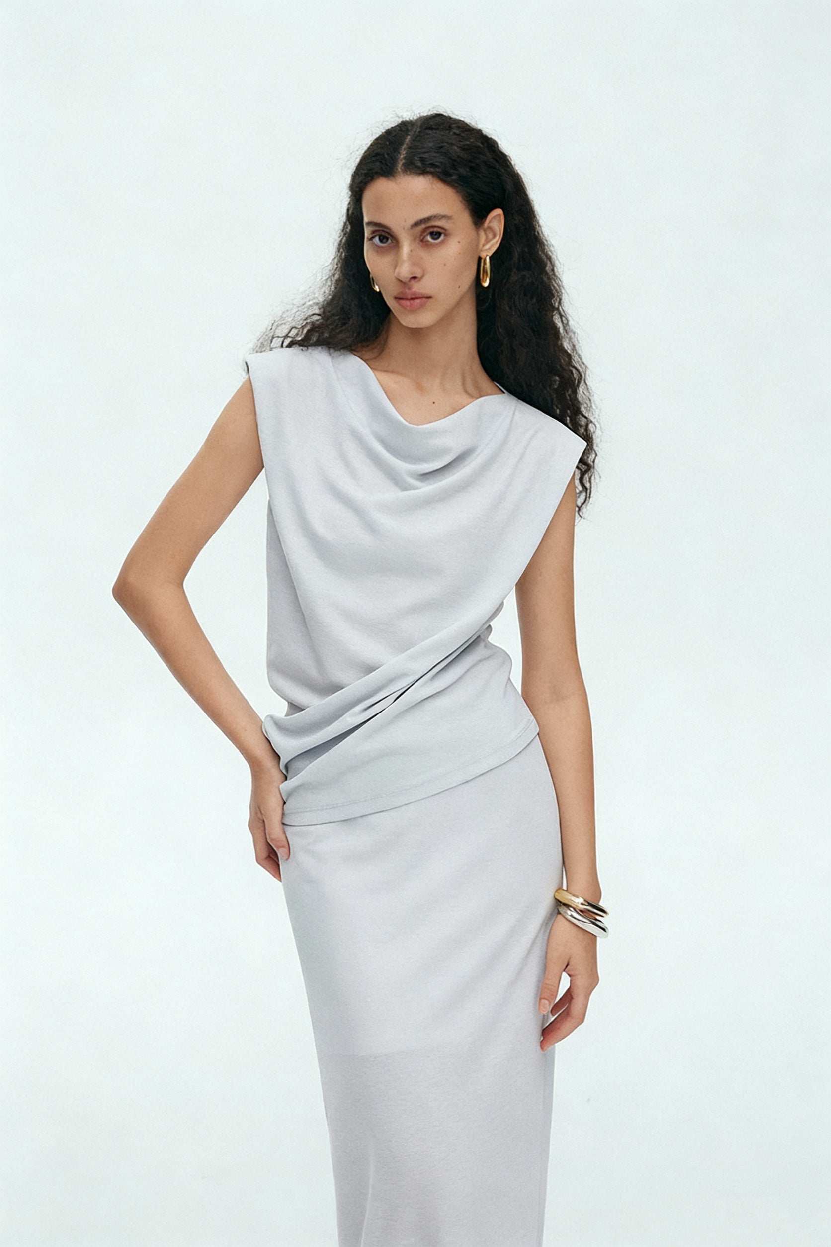 BapHood light gray sleeveless draped top paired with smooth flowing maxi skirt in minimalist set