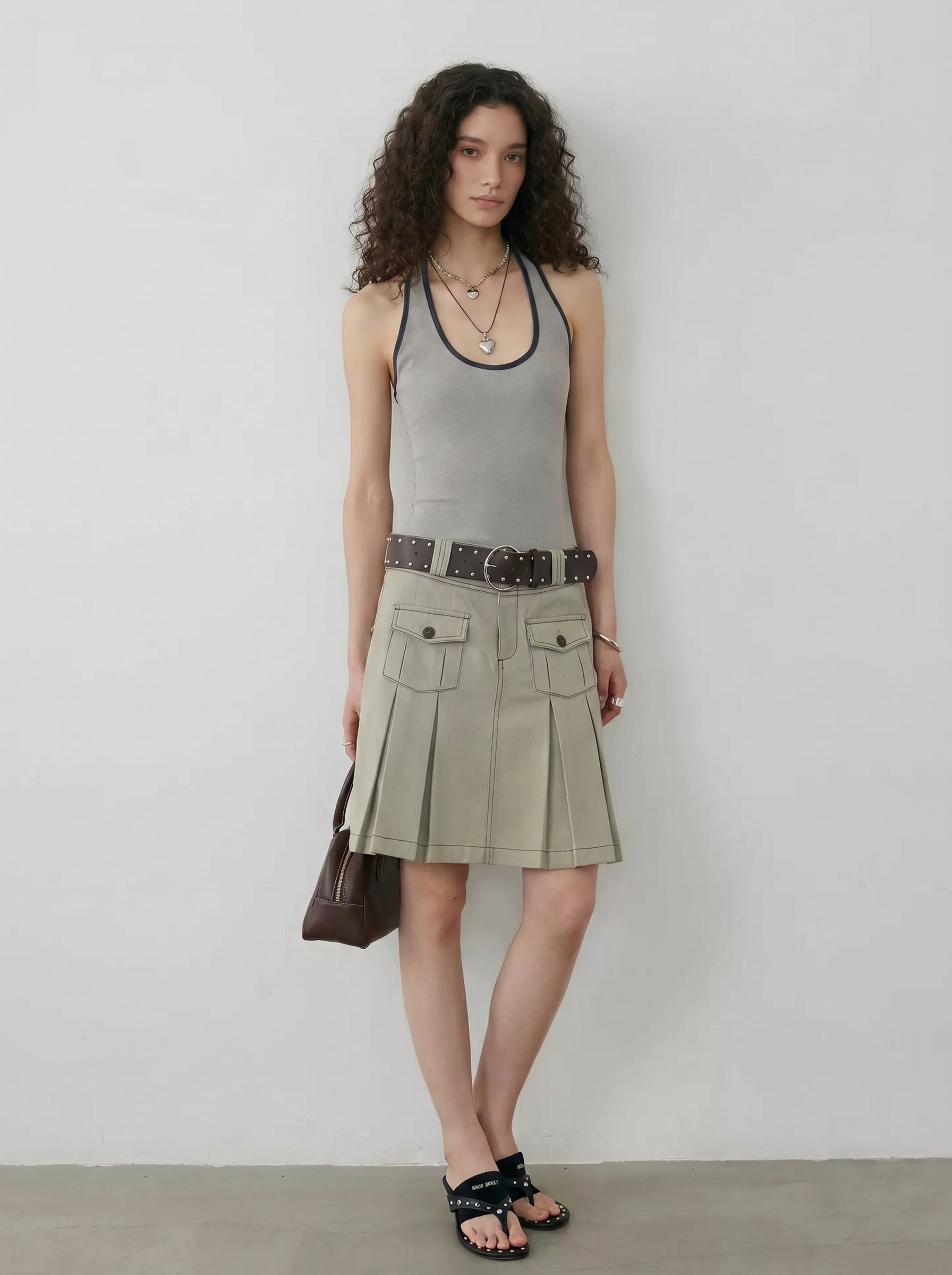 BapHood khaki grey knee-length utility skirt with structured pleats and contrast stitch details.
