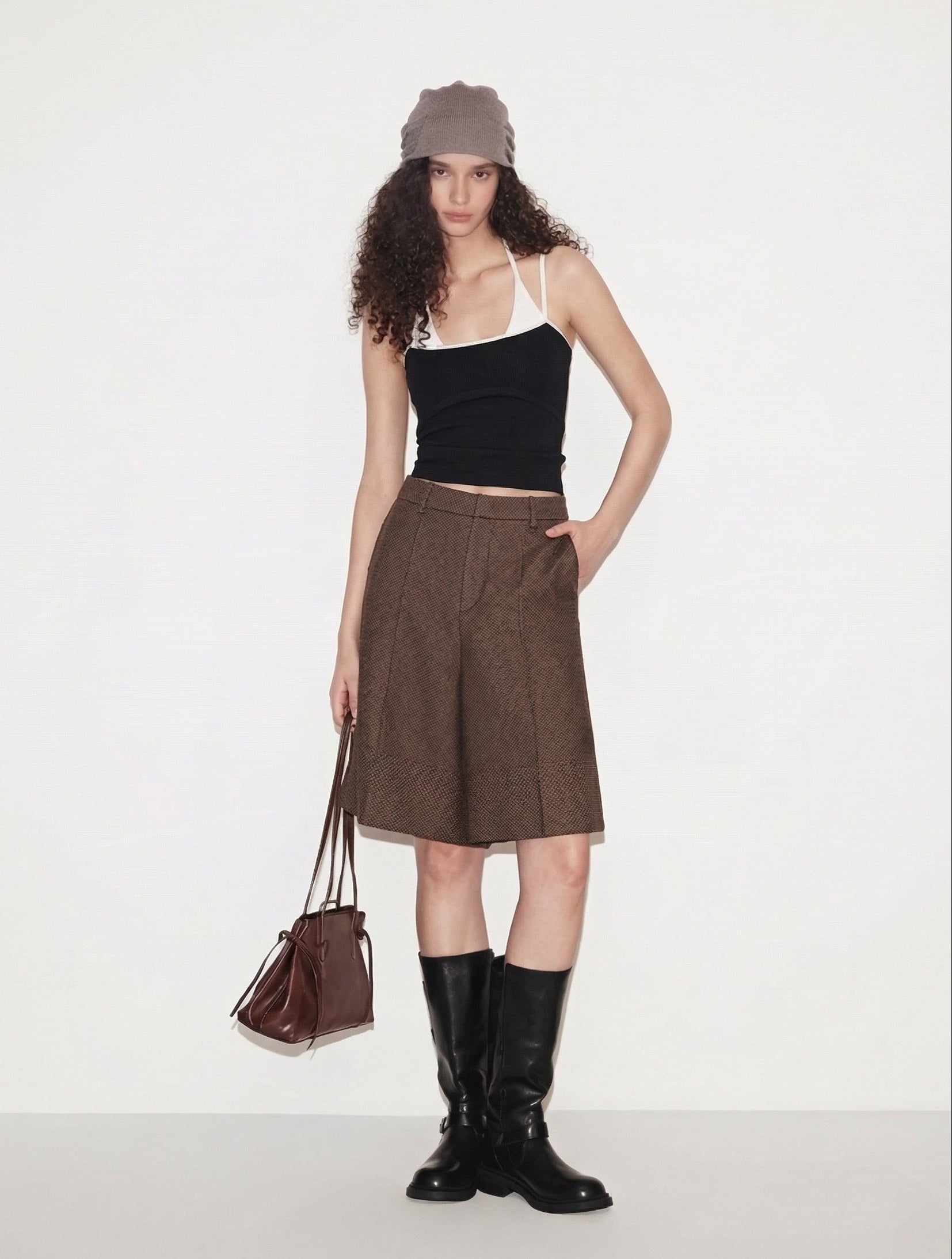 BapHood layered black tank top and brown tailored shorts.