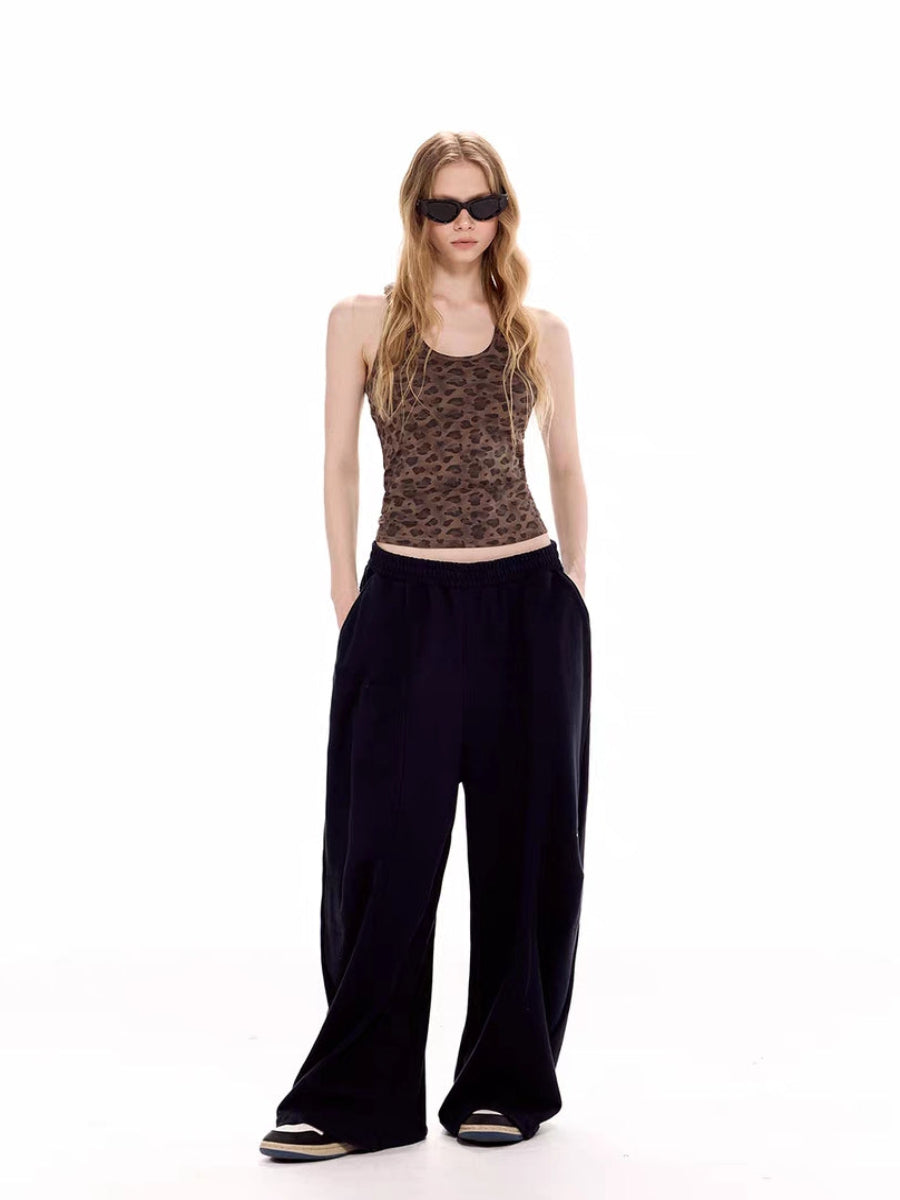 Full-body front view of leopard tank top styled with wide-leg black pants