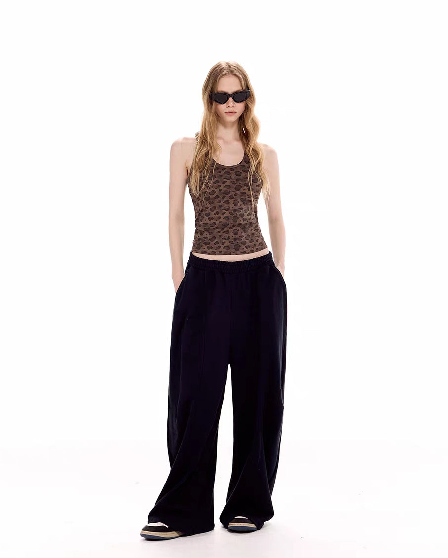 Full-body front view of leopard tank top styled with wide-leg black pants