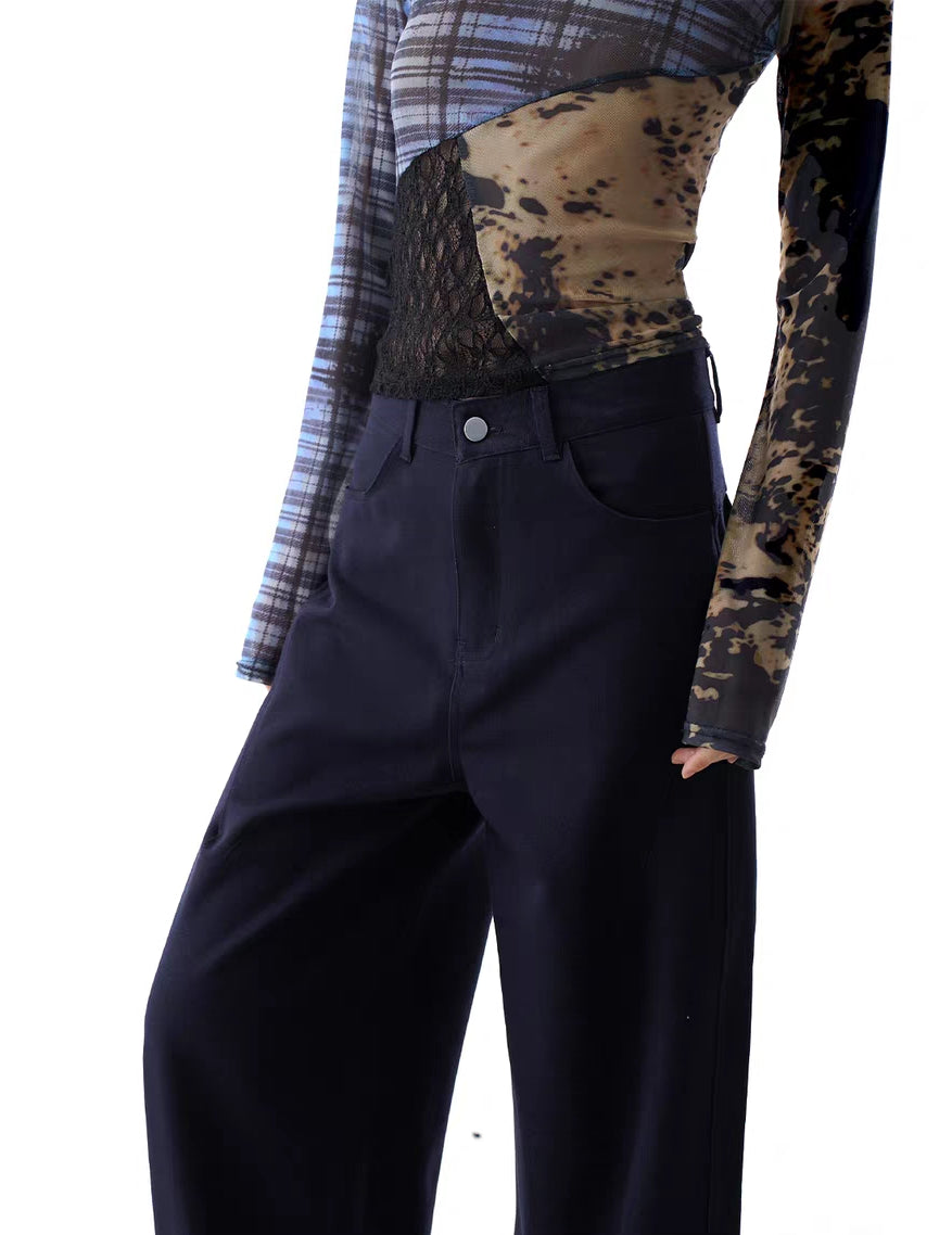 Close-up of waistband, button and zip closure on navy trousers