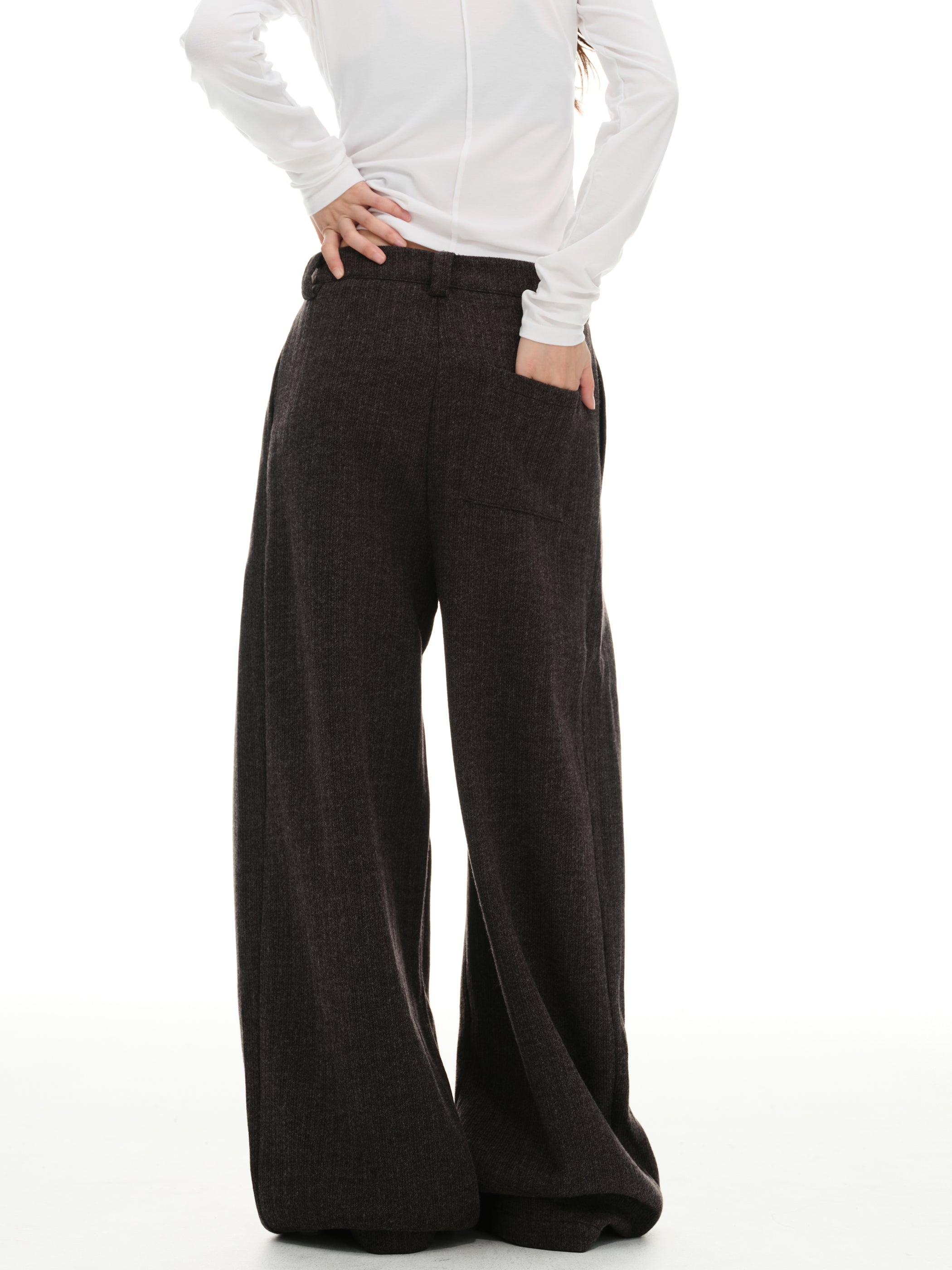 Back view of dark mocha wide-leg trousers with relaxed patch pocket