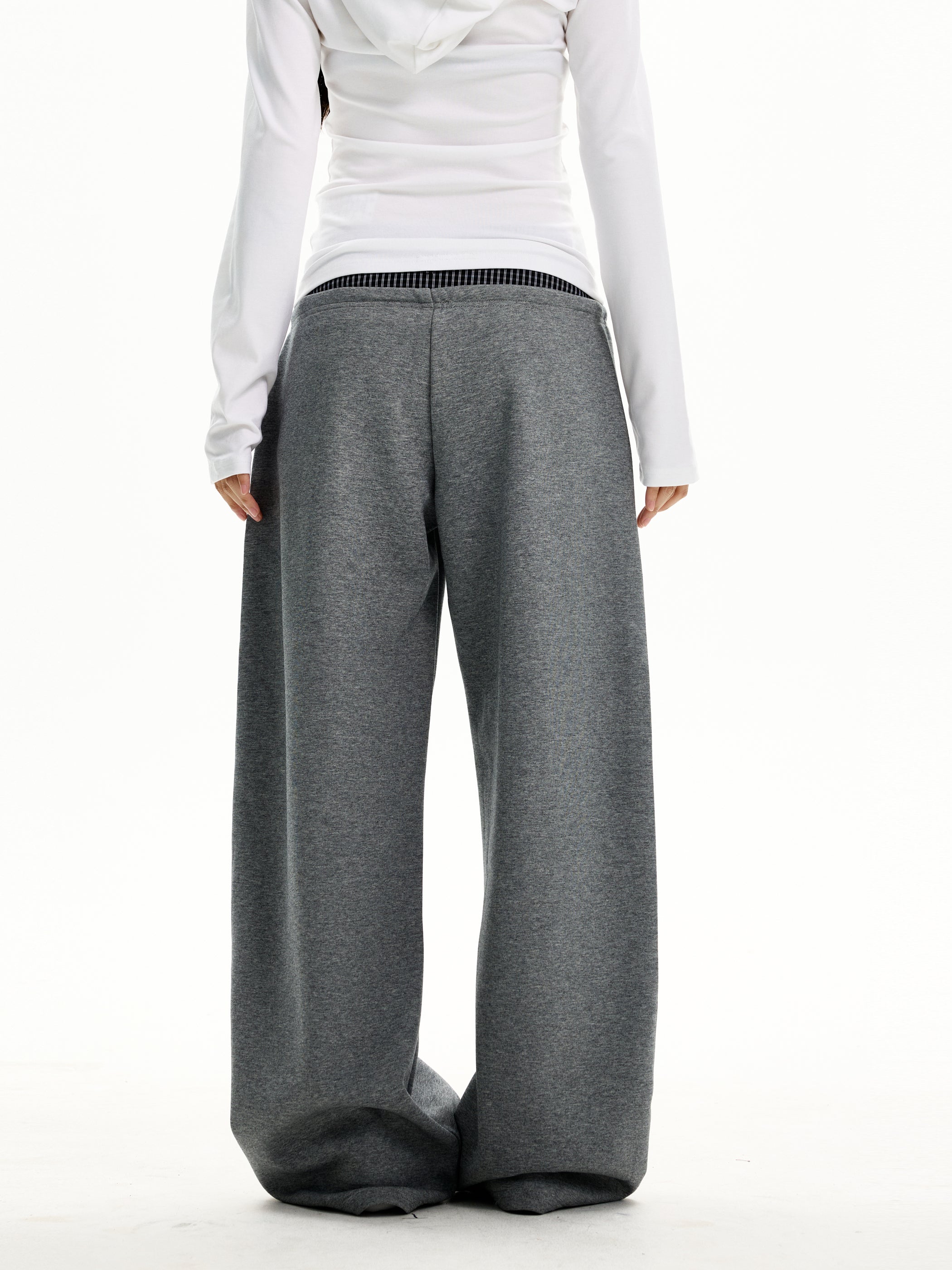 Back view of heather grey wide-leg trousers with floor-grazing hem