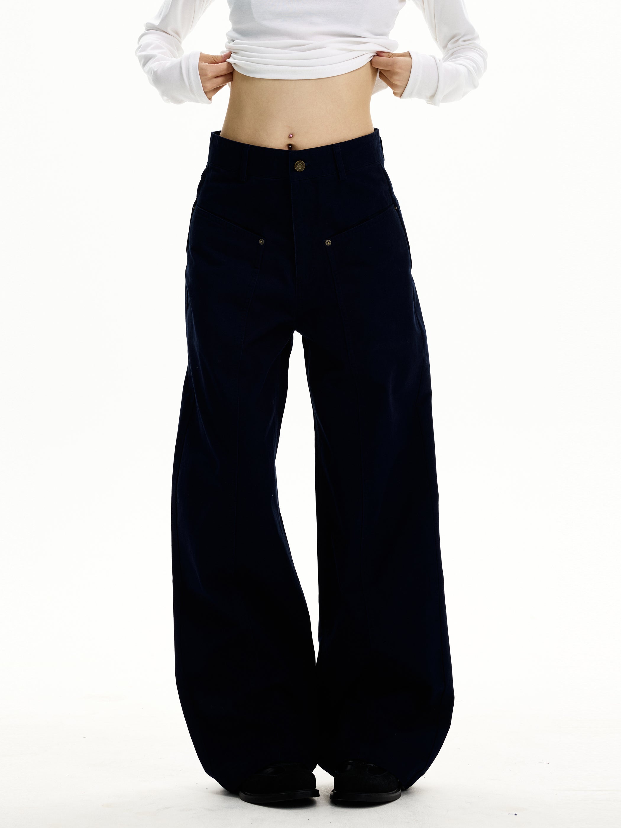Close-up of ink navy wide-leg trousers showing V-shaped front yoke