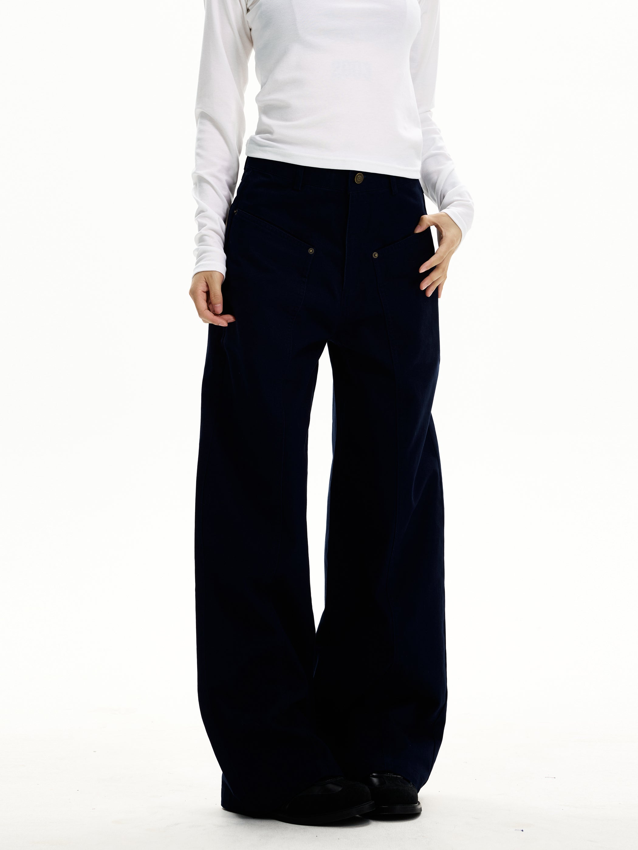 Model wearing ink navy utility wide-leg trousers with extra-long hem