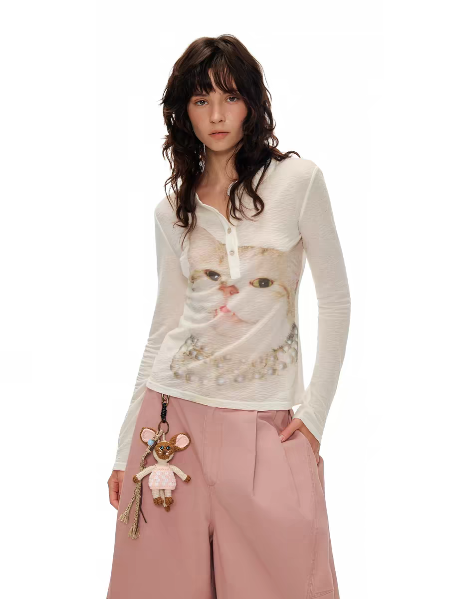 Model wearing ivory kitty print Henley long sleeve top, front view