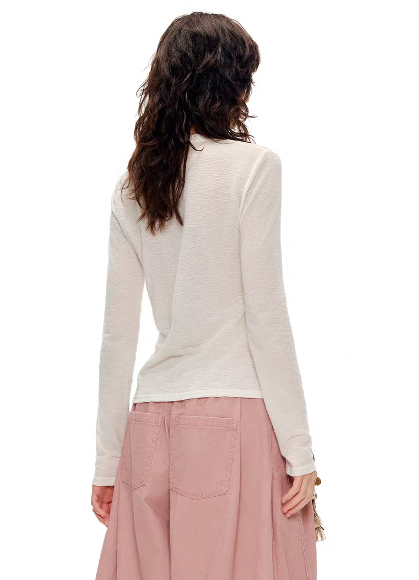 Model wearing ivory kitty print Henley long sleeve top, back view