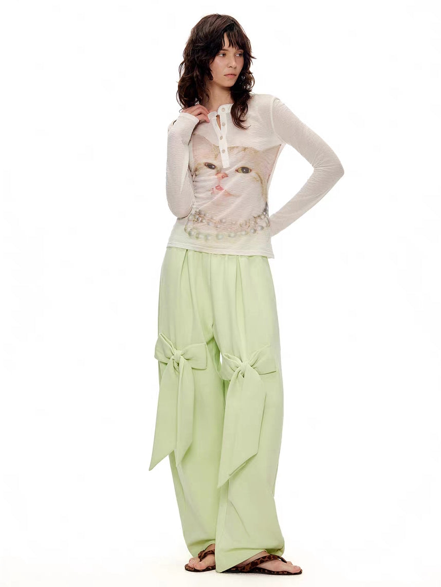 Model wearing ivory kitty print Henley long sleeve top, front view