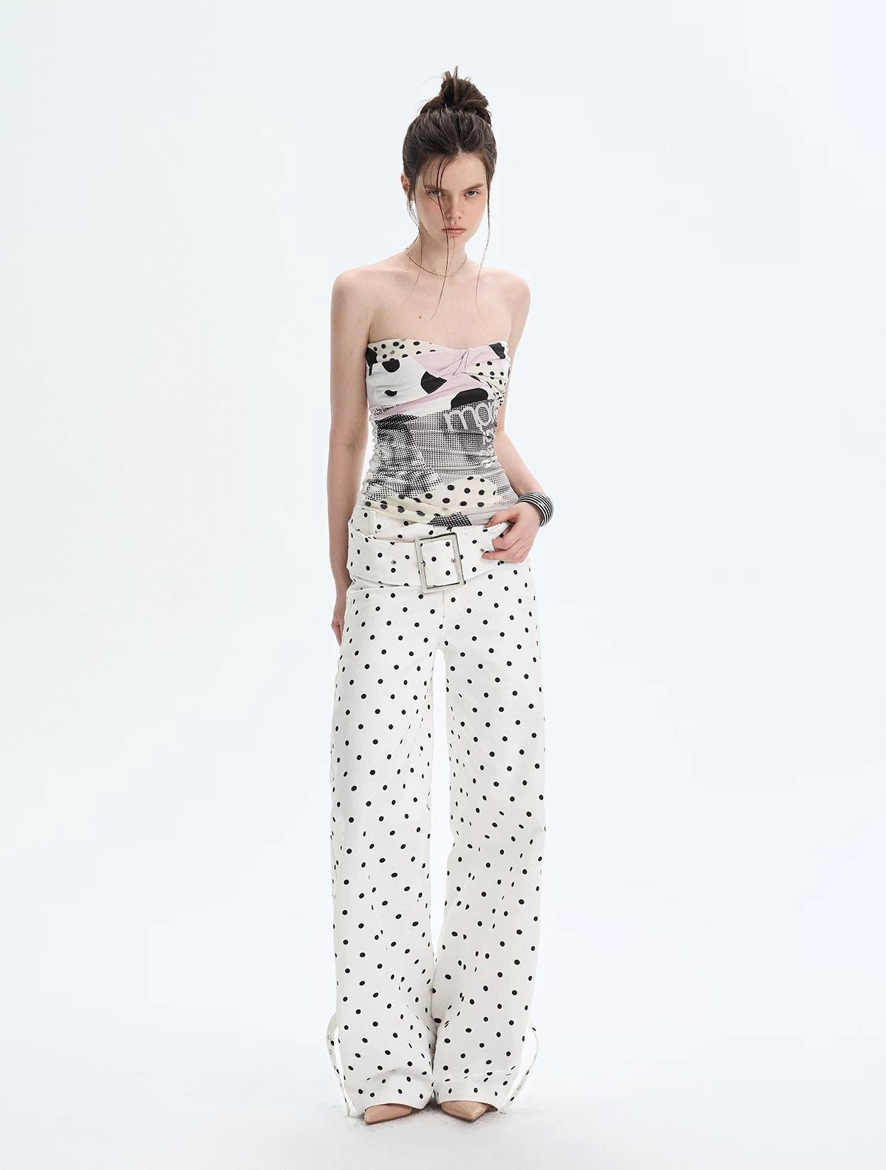 Model wearing polka collage twist tube top with matching wide-leg pants, front view