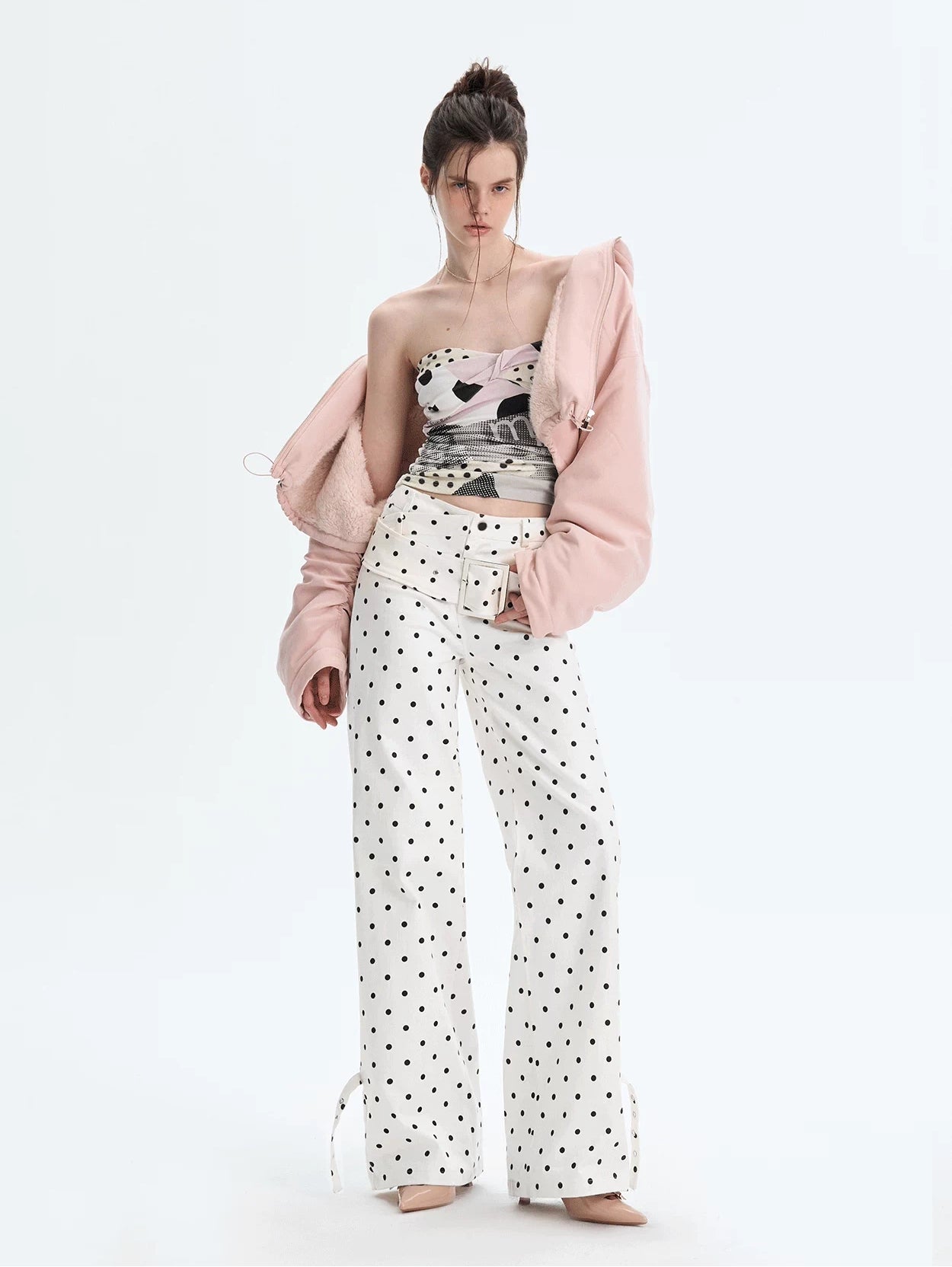 Model wearing strapless polka collage tube top with jacket, front view