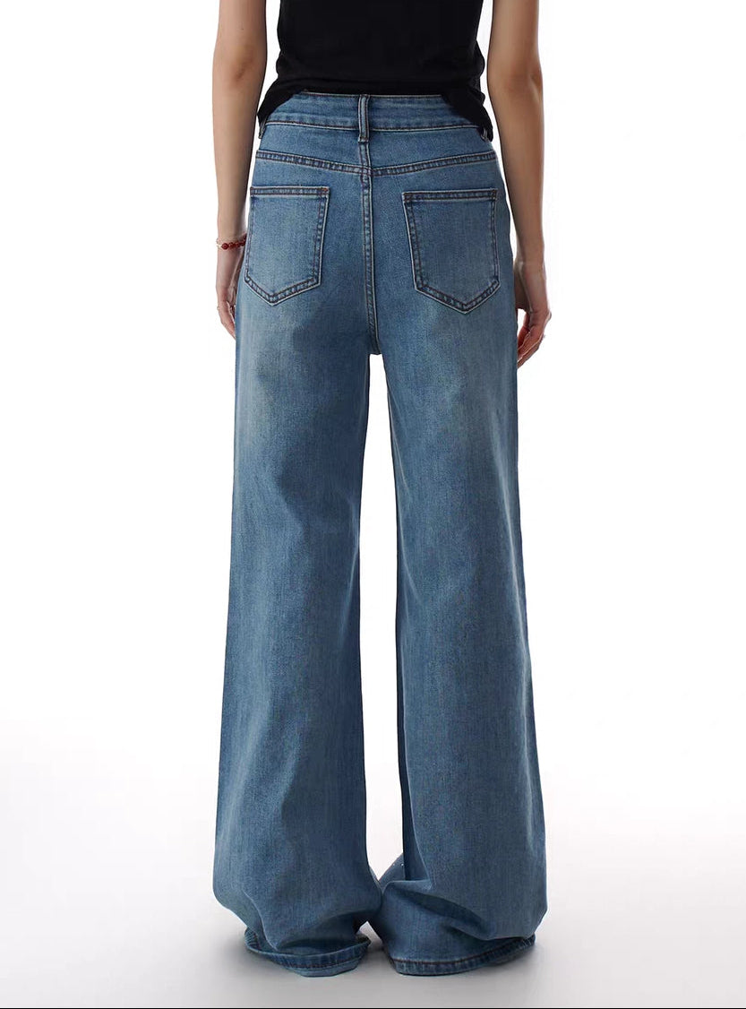 Back view of rhinestone flare jeans on model