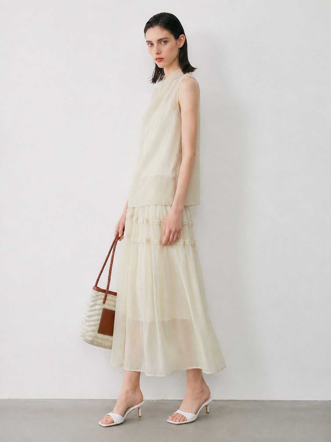 BapHood sand khaki two-piece skirt set shown from the side with a sleeveless cowl top and airy
