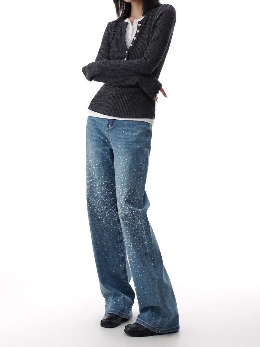 Side angle of blue rhinestone flare jeans showing sparkle fade along the leg