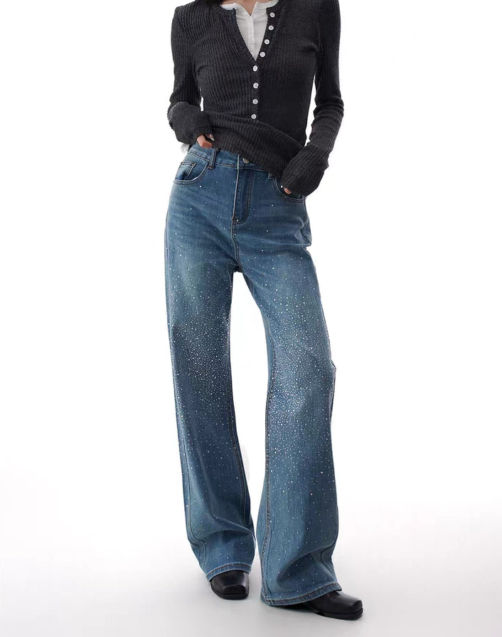 Model wearing blue flare jeans with rhinestone stardust gradient detailing
