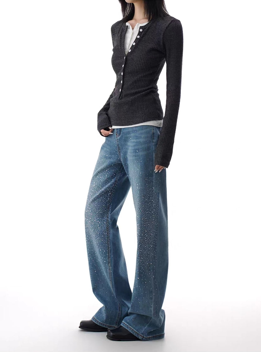 Side angle of blue rhinestone flare jeans showing sparkle fade along the leg