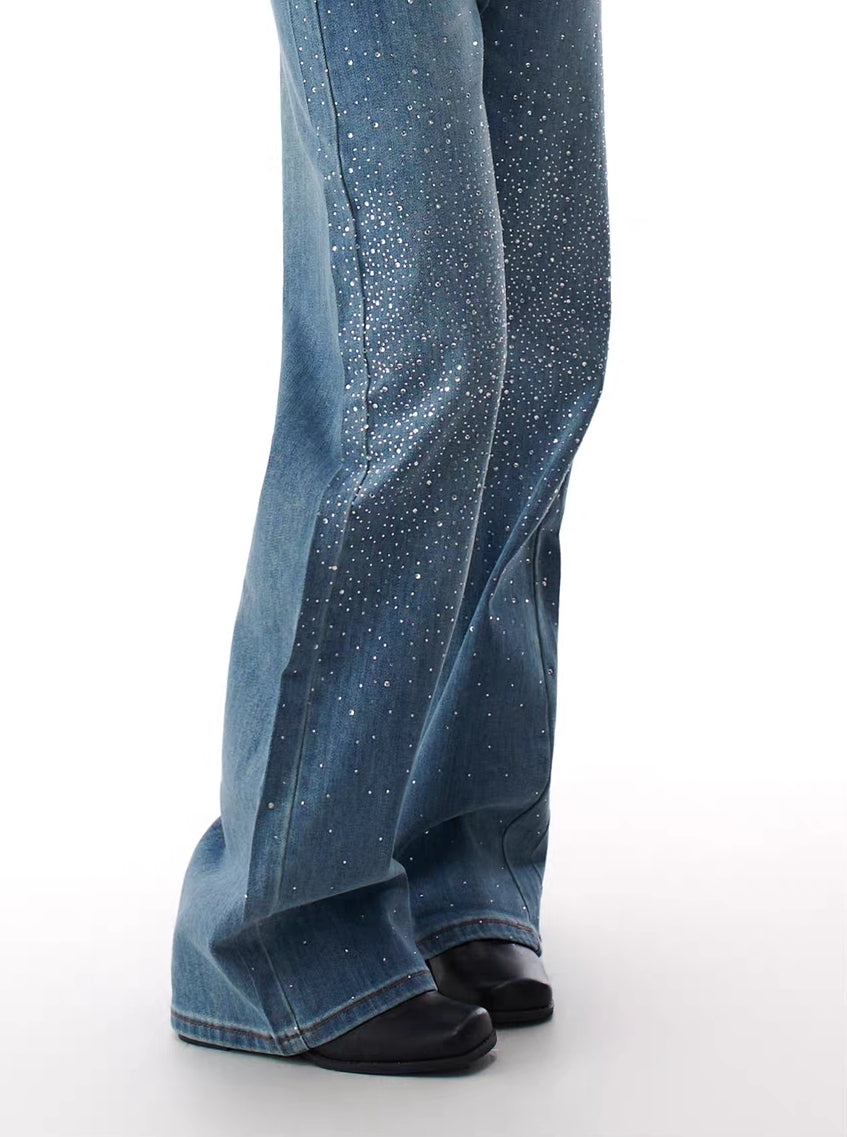 Model wearing blue flare jeans with rhinestone stardust gradient detailing