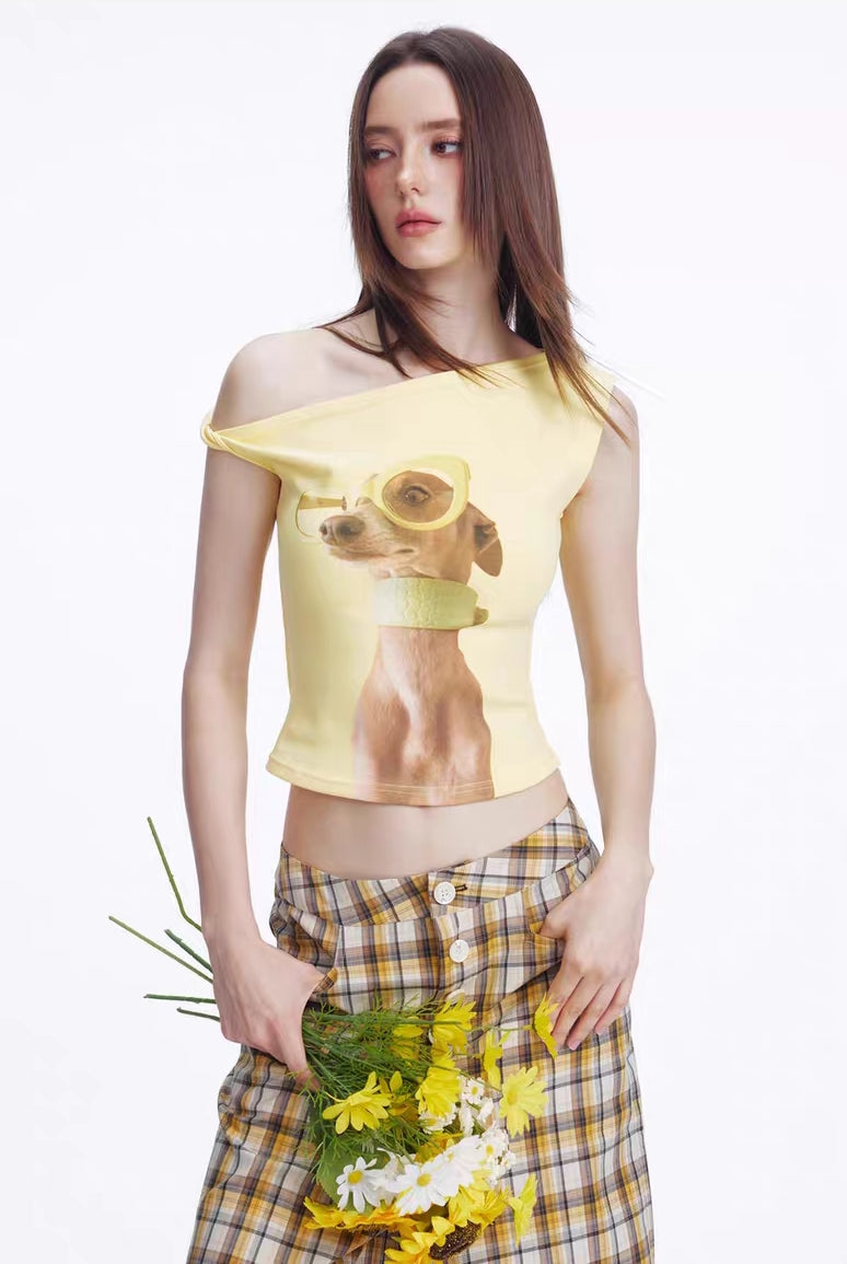Model wearing lemon yellow one-shoulder crop top with puppy graphic, front view