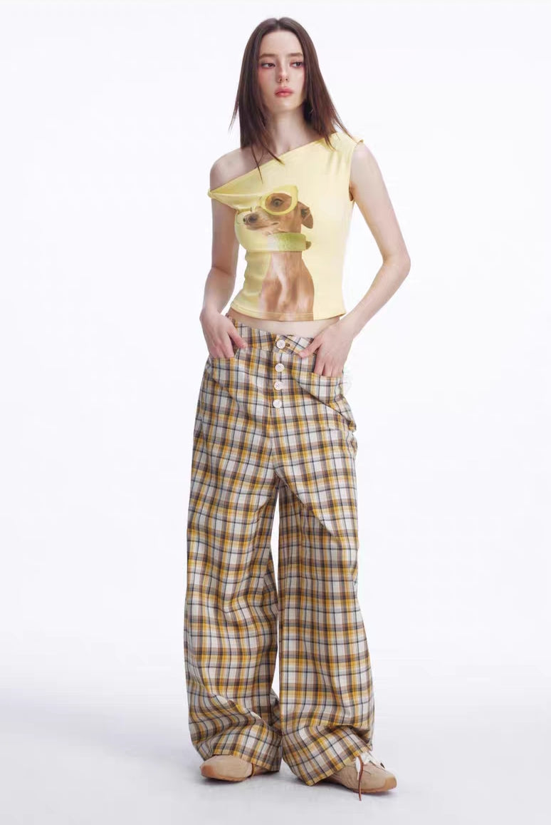 Full body front view of yellow asymmetrical puppy graphic top styled with plaid pants