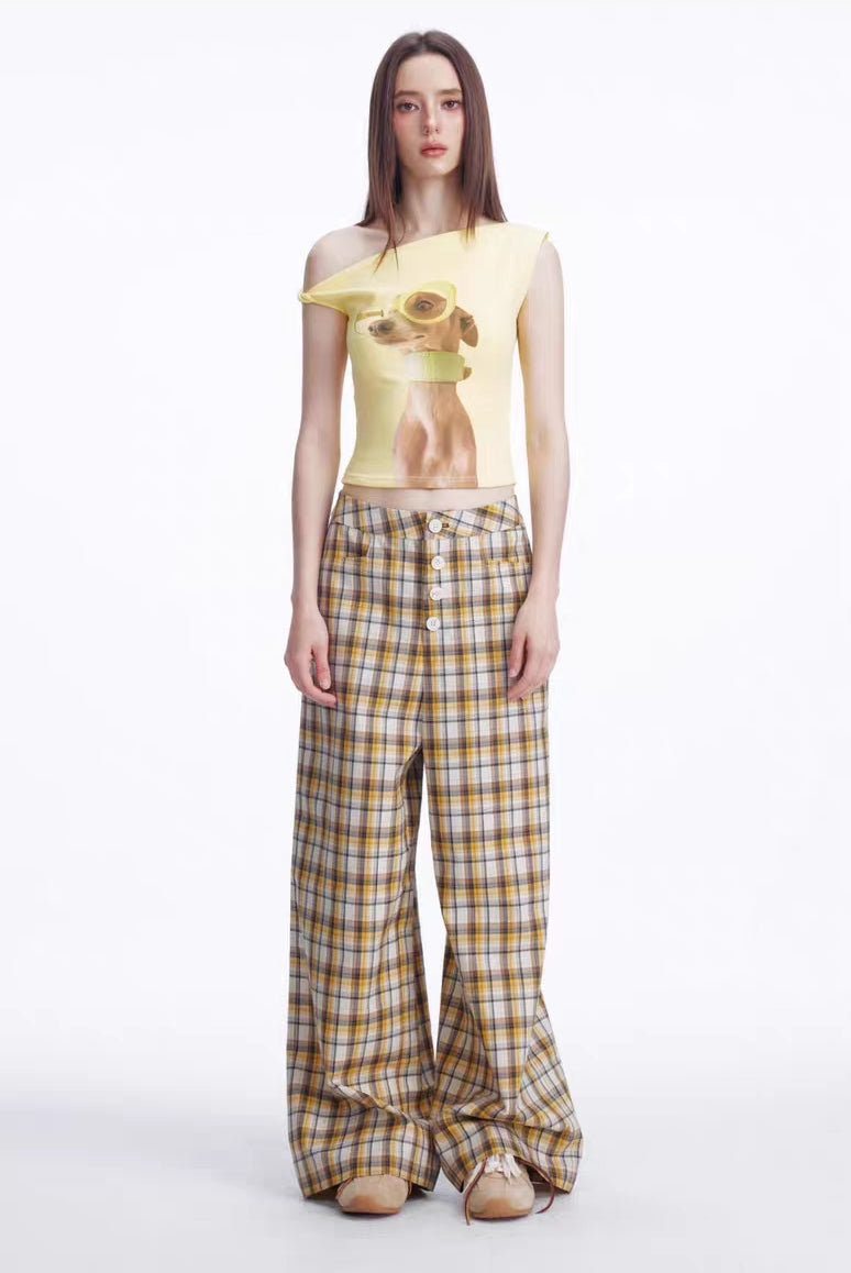 Full body front view of yellow asymmetrical puppy graphic top styled with plaid pants