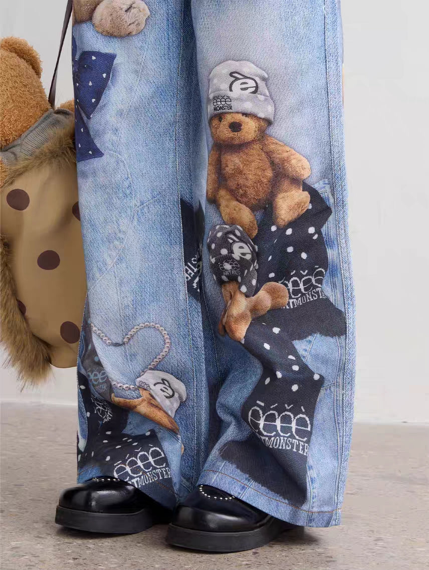 Close-up of leg graphic on light wash jeans featuring teddy bear and polka-dot scarf print