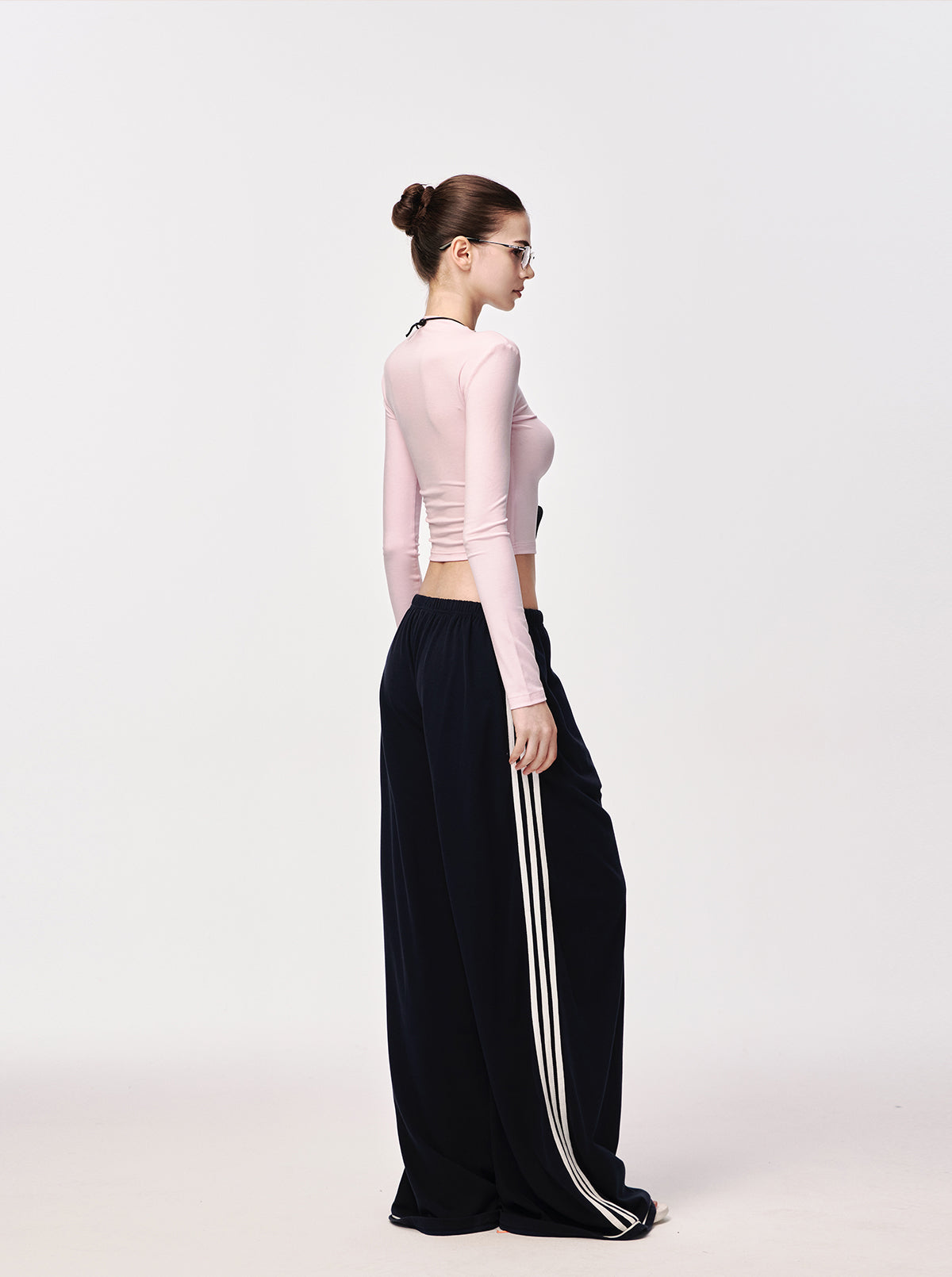 Close-up of baby pink second-skin top neckline and shoulder on model