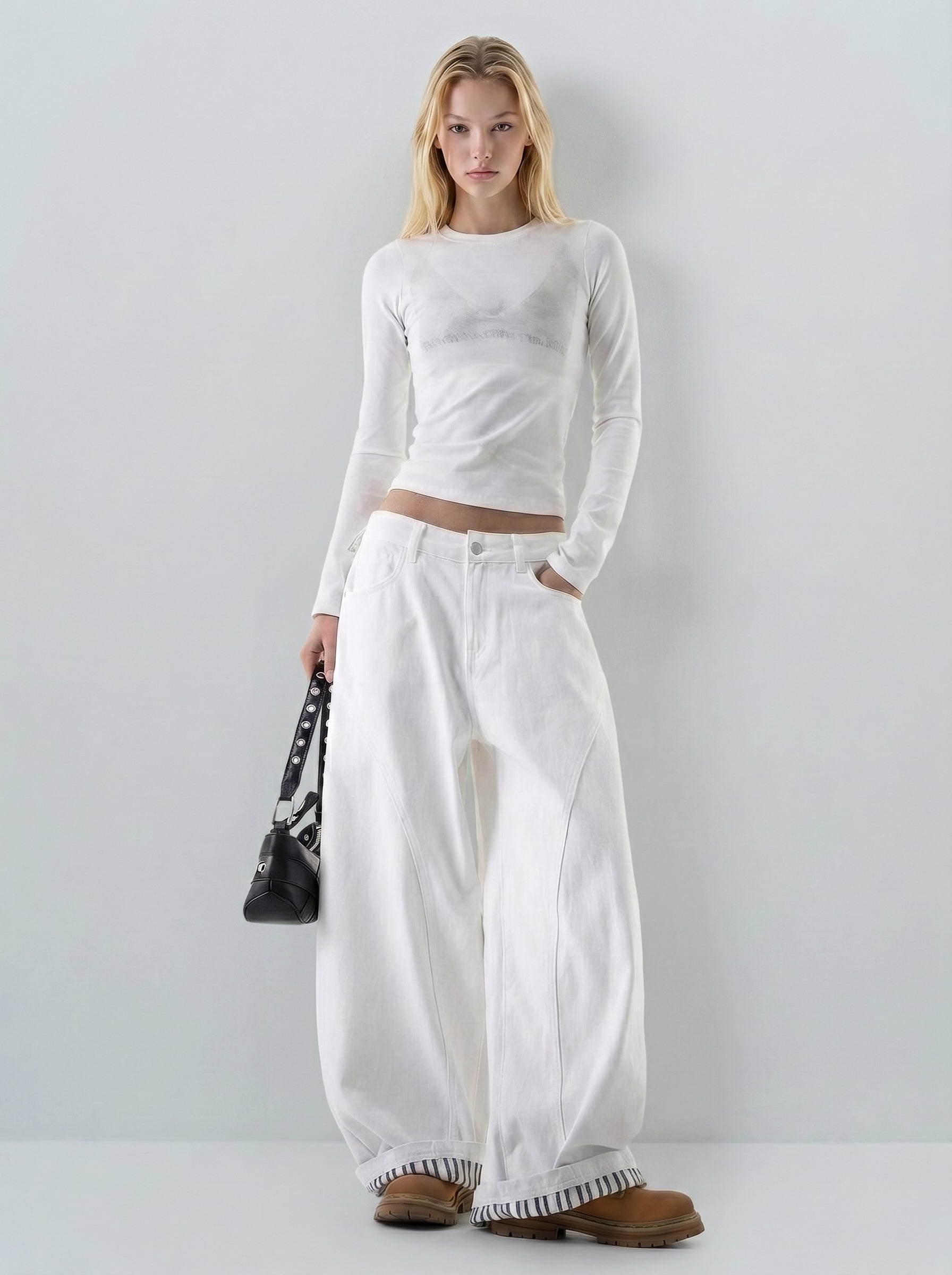 Full-body view of clean white wide-leg denim jeans with contrast cuff