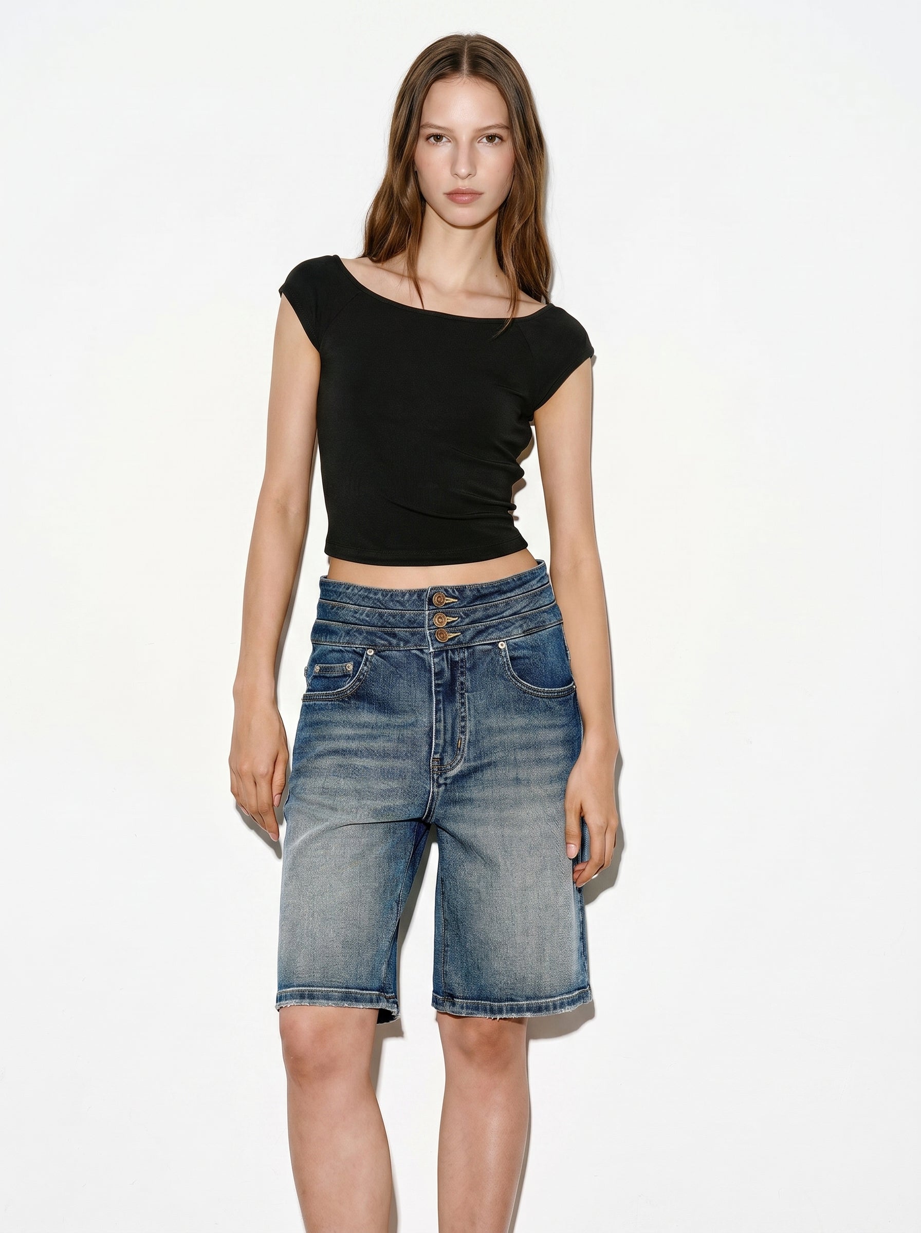 Black cap sleeve crop top styled with denim shorts