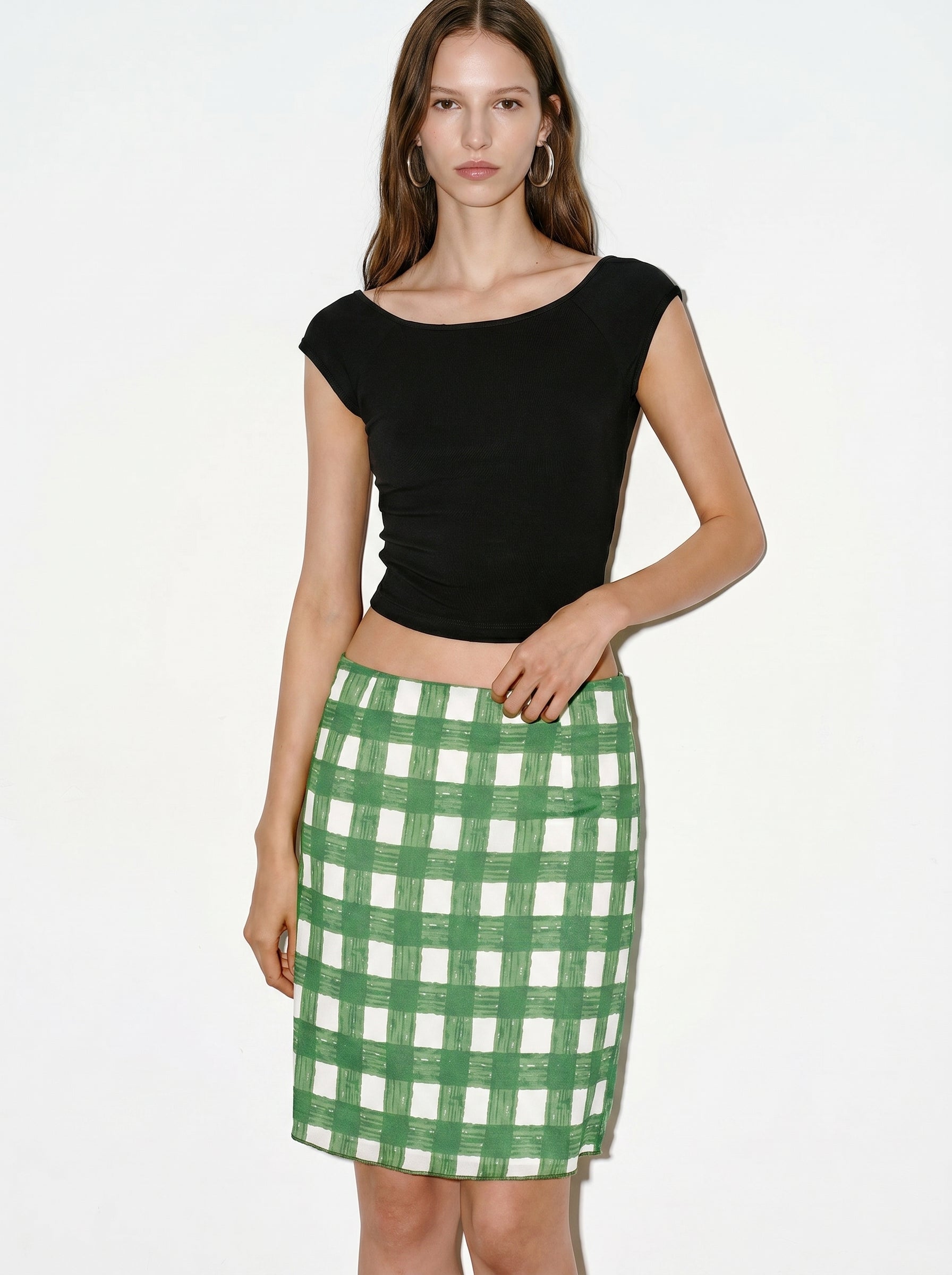 Black cap sleeve crop top styled with green check skirt front view
