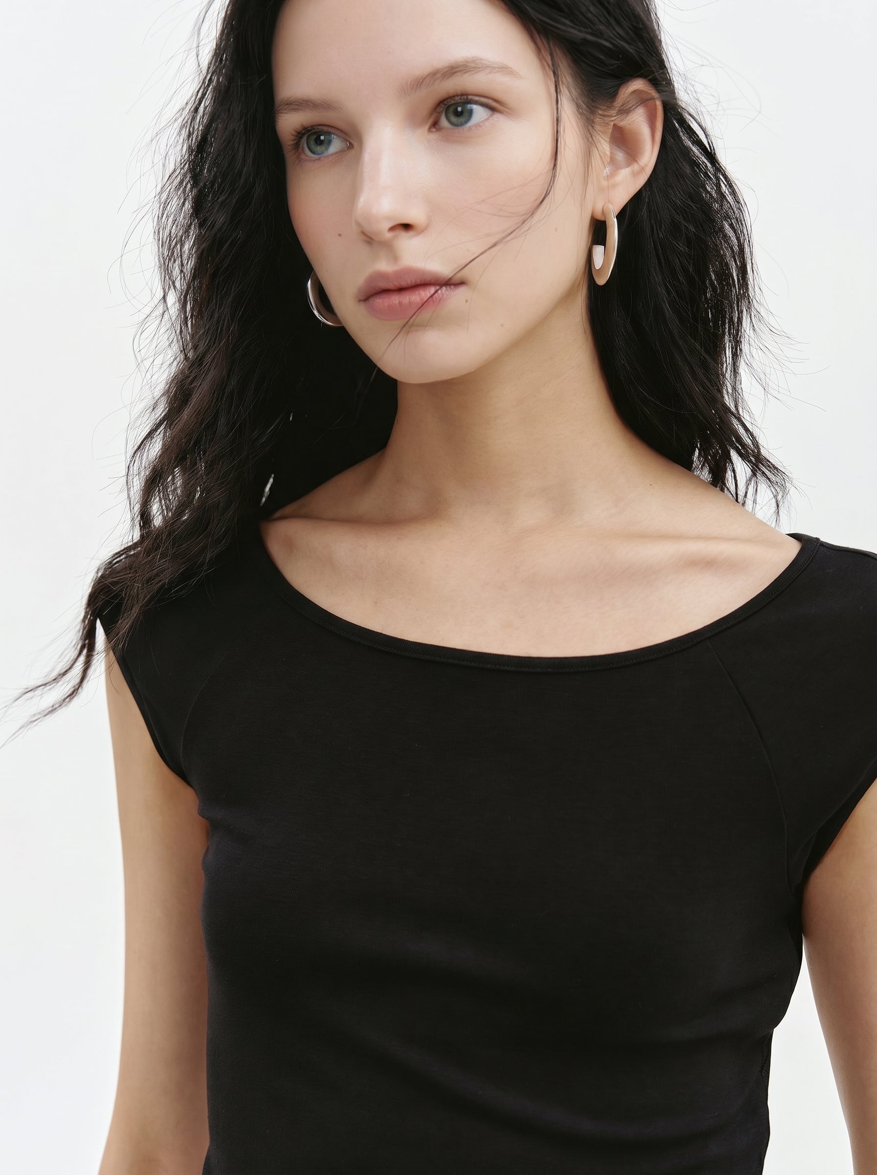 Close-up of black cap sleeve crop top with wide neckline