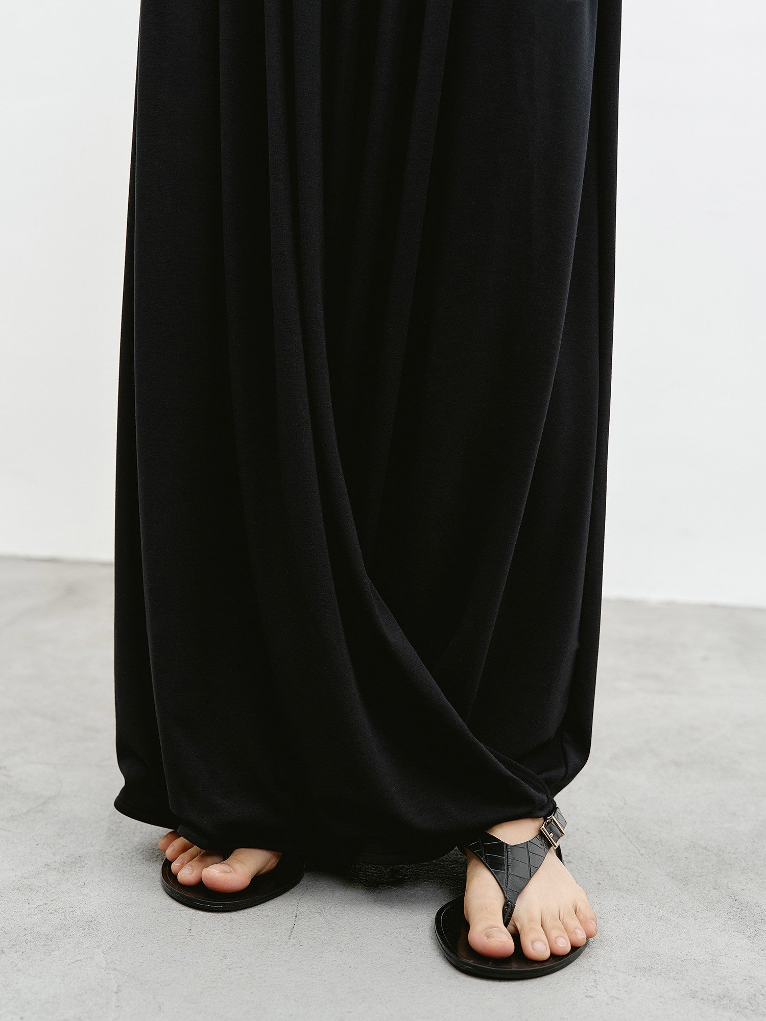 Hem and draped fabric detail of black maxi skirt